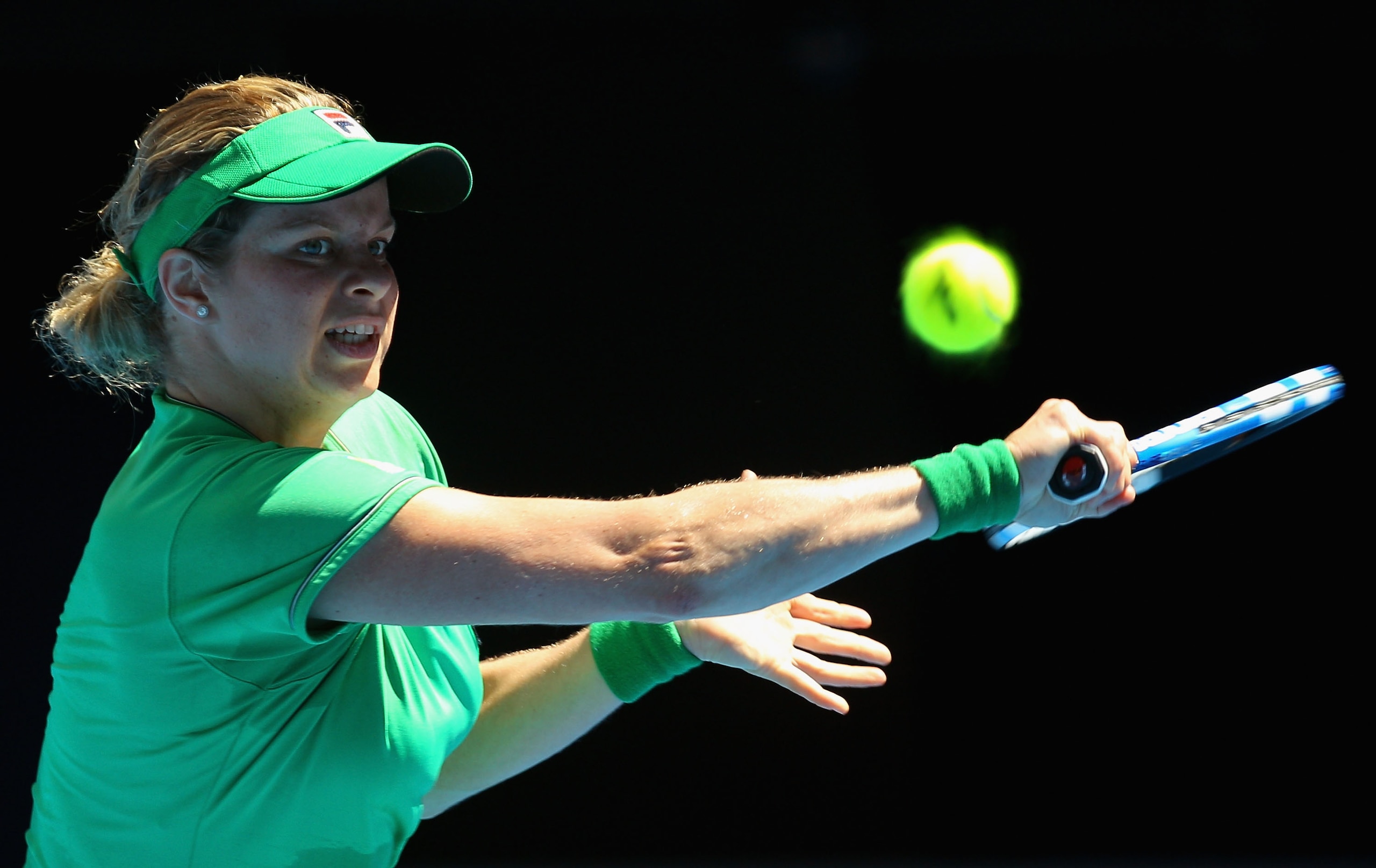 MELBOURNE, AUSTRALIA - JANUARY 20:  Kim Clijsters of Belgium plays a backhand in her second round match against Carla Suarez Navarro of Spain during day four of the 2011 Australian Open at Melbourne Park on January 20, 2011 in Melbourne, Australia.  (Phot