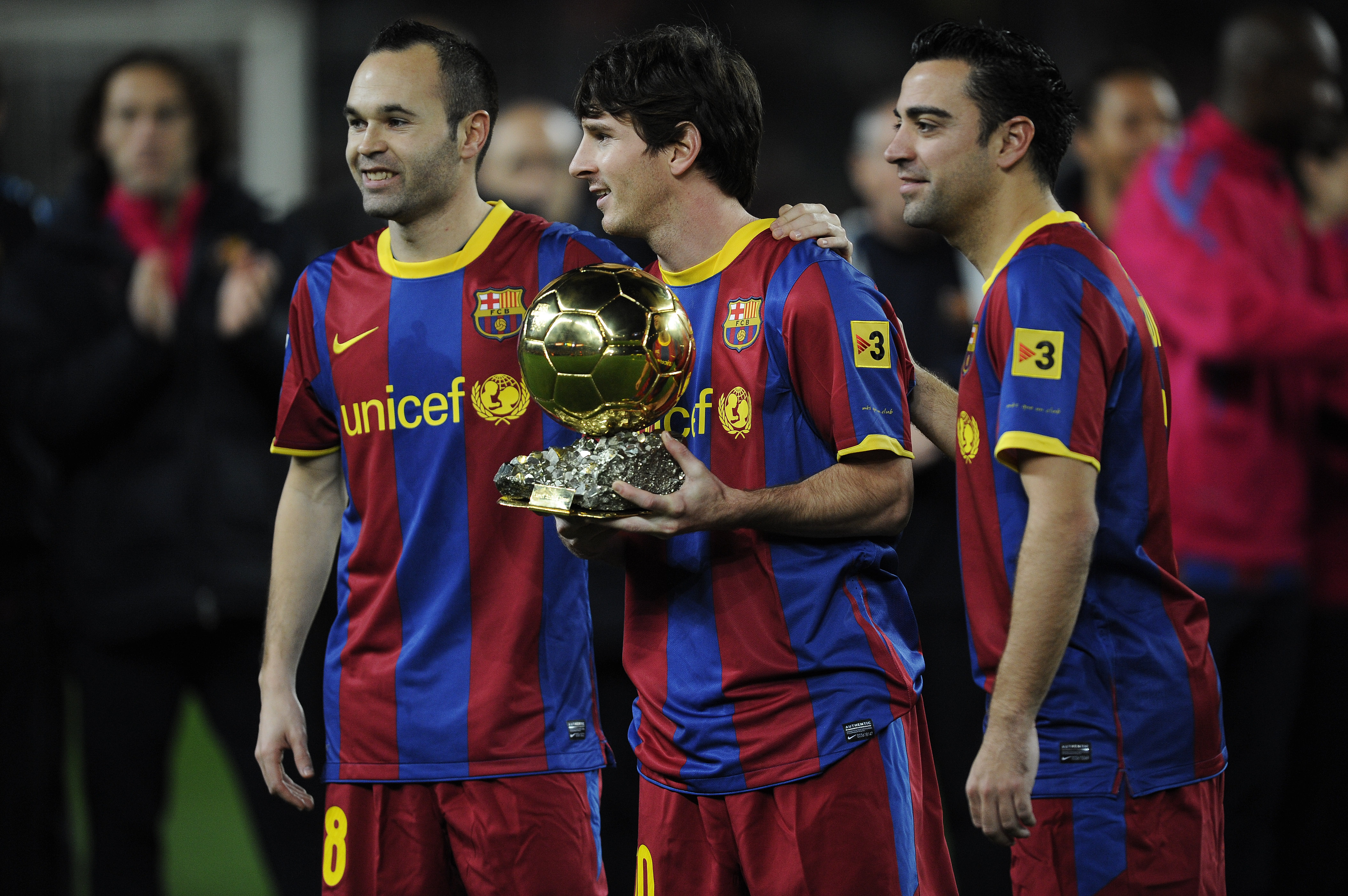 BARCELONA, SPAIN - JANUARY 12:  Lionel Messi of FC Barcelona (C) holds the Ballon d'Or trophy flanked by his teammates Andres Iniesta (L) and Xavi Hermandez prior the Copa del Rey quarter final first leg match FC Barcelona and Betis at Camp Nou on January