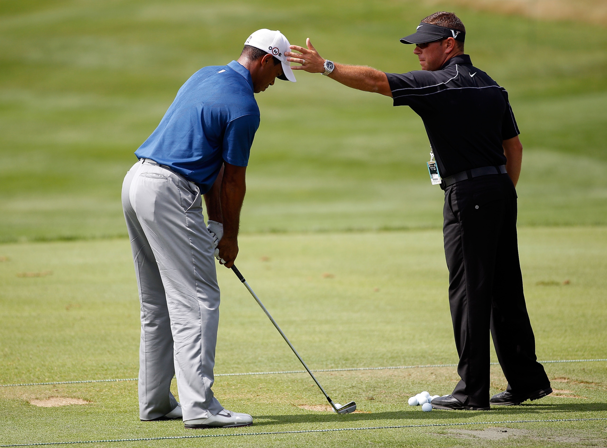 KOHLER, WI - AUGUST 14: Tiger Woods (L) works with golf instructor Sean Foley on the practice ground prior to the start of the third round of the 92nd PGA Championship on the Straits Course at Whistling Straits on August 14, 2010 in Kohler, Wisconsin. ( KOHLER, WI - AUGUST 14: Tiger Woods (L) works with golf instructor Sean Foley on the practice ground prior to the start of the third round of the 92nd PGA Championship on the Straits Course at Whistling Straits on August 14, 2010 in Kohler, Wisconsin. (