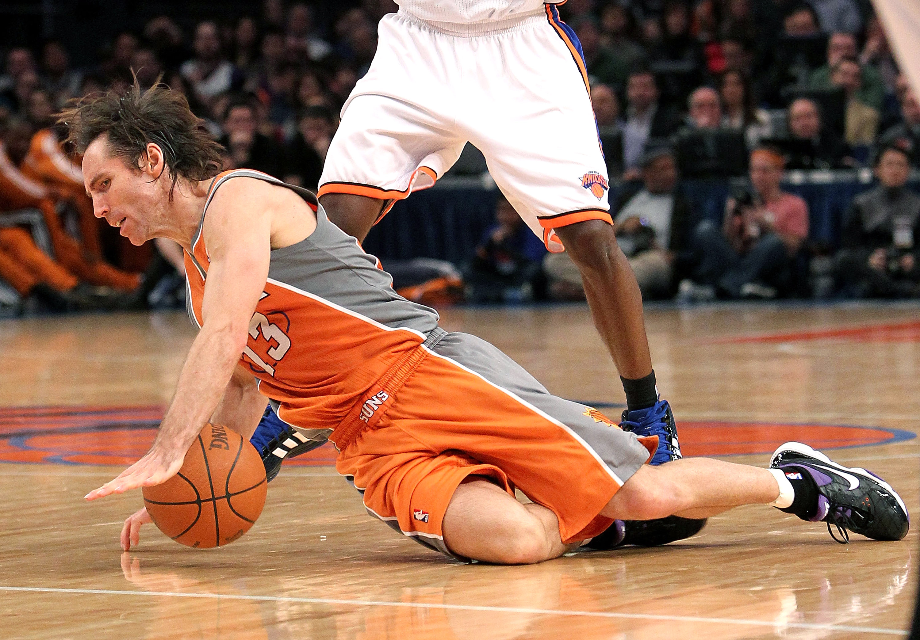 NEW YORK, NY - JANUARY 17:  Steve Nash #13 of the Phoenix Suns falls to the court against the New York Knicks at Madison Square Garden on January 17, 2011 in New York City. NOTE TO USER: User expressly acknowledges and agrees that, by downloading and or u