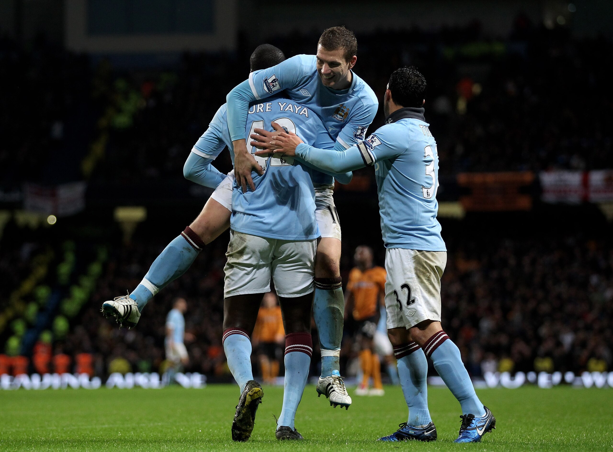 MANCHESTER, ENGLAND - JANUARY 15:  Yaya Toure of Manchester City celebrates scoring his team's third goal with team mates Edin Dzeko and Carlos Tevez (R) during the Barclays Premier League match between Manchester City and Wolverhampton Wanderers at the C