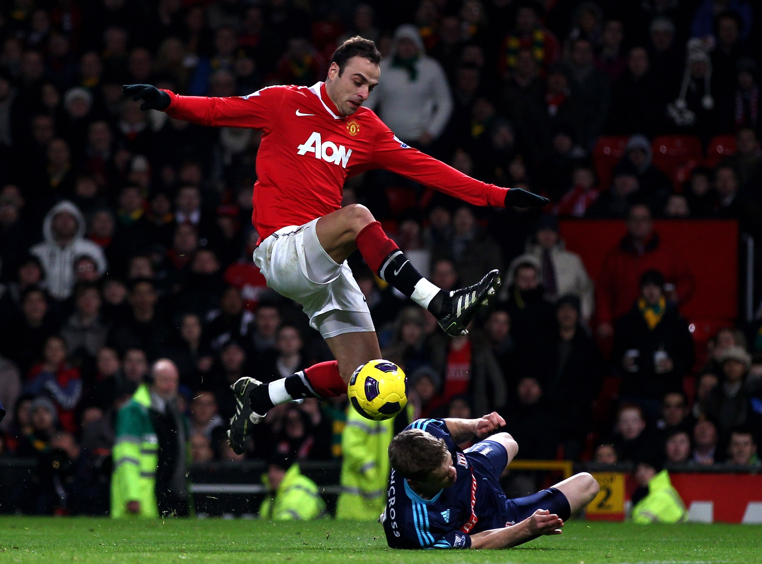 MANCHESTER, ENGLAND - JANUARY 04:  Dimitar Berbatov of Manchester United is challenged by Ryan Shawcross of Stoke City during the Barclays Premier League match between Manchester United and Stoke City at Old Trafford on January 4, 2011 in Manchester, Engl