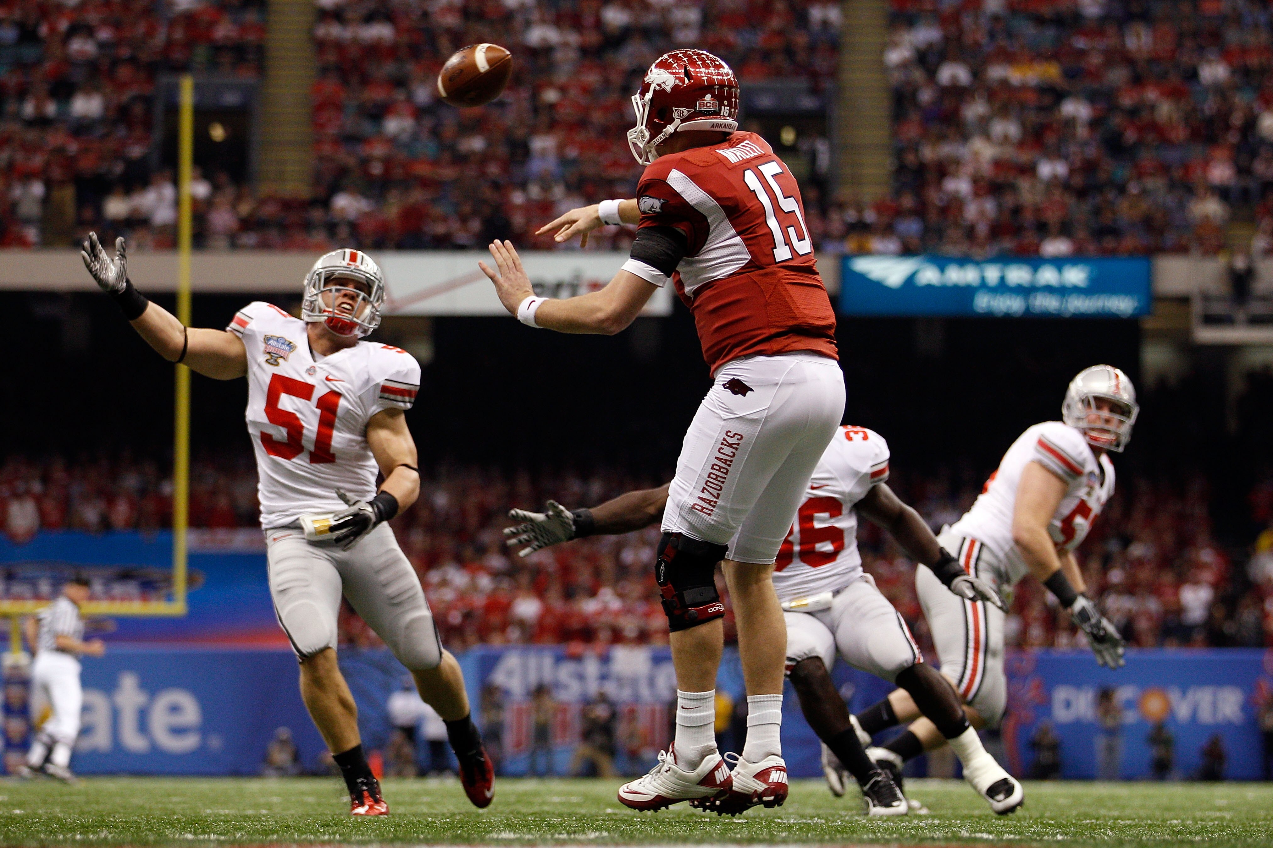 NEW ORLEANS, LA - JANUARY 04:  Ryan Mallett #15 of the Arkansas Razorbacks throws a pass over Ross Homan #51 of the Ohio State Buckeyes during the Allstate Sugar Bowl at the Louisiana Superdome on January 4, 2011 in New Orleans, Louisiana.  (Photo by Chri
