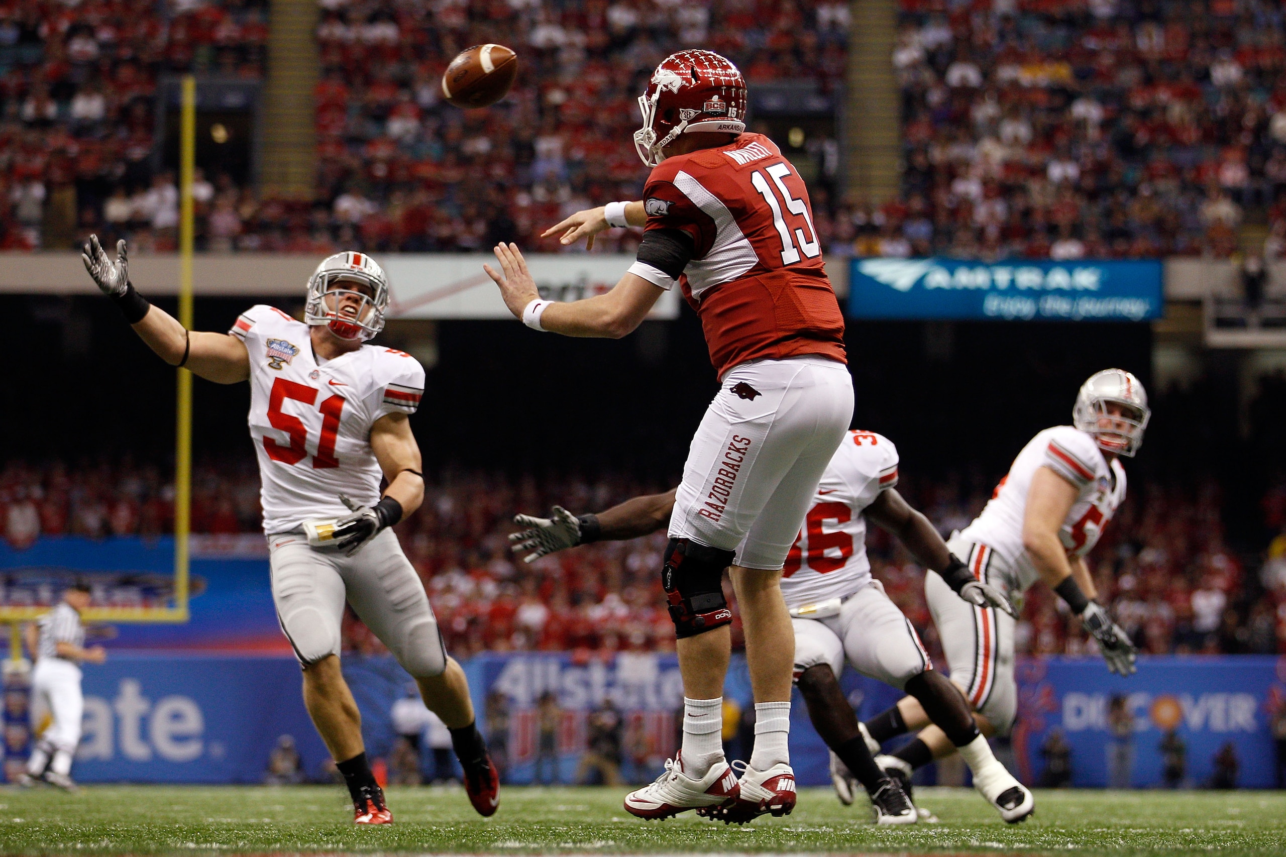 NEW ORLEANS, LA - JANUARY 04:  Ryan Mallett #15 of the Arkansas Razorbacks throws a pass over Ross Homan #51 of the Ohio State Buckeyes during the Allstate Sugar Bowl at the Louisiana Superdome on January 4, 2011 in New Orleans, Louisiana.  (Photo by Chri