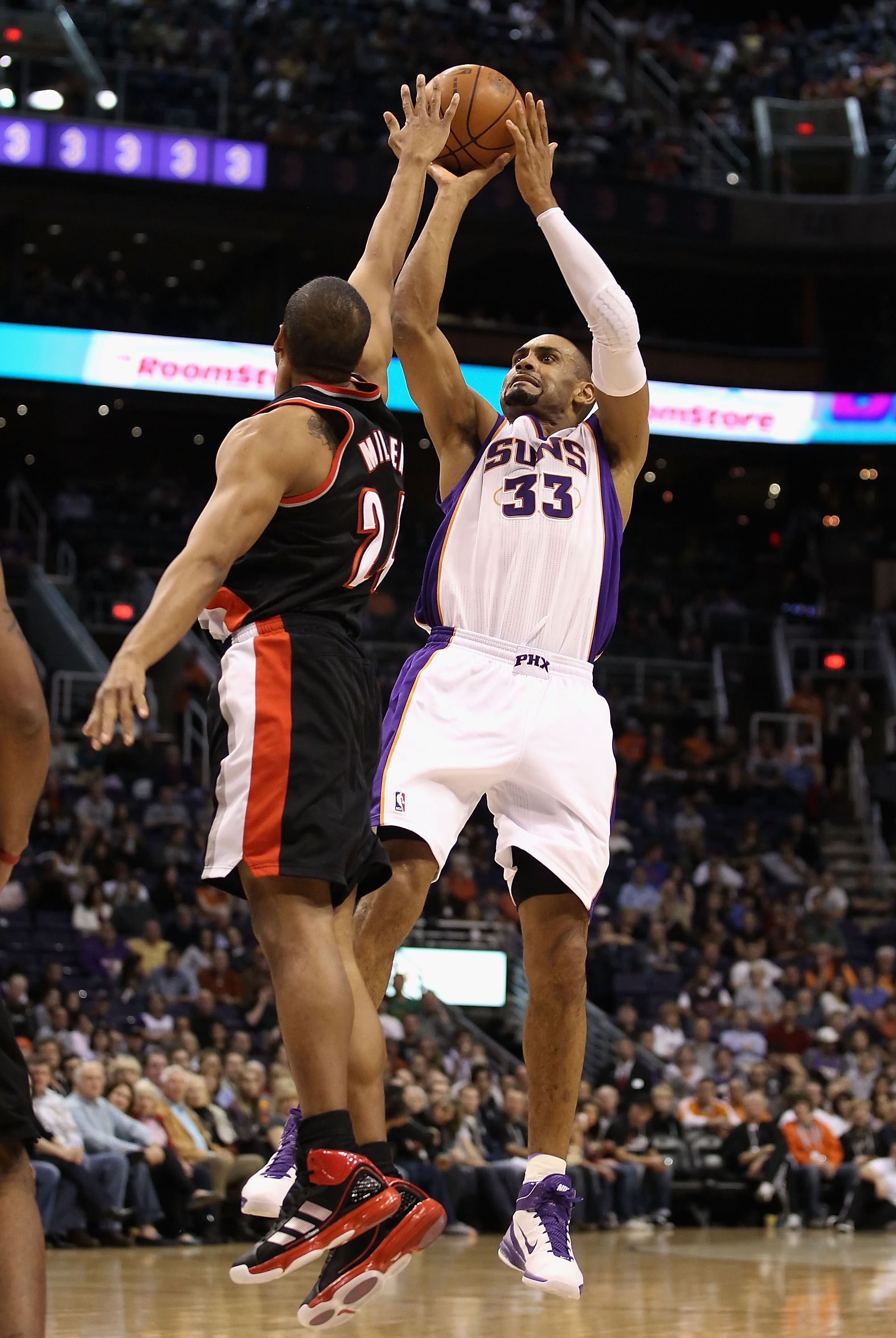 PHOENIX, AZ - JANUARY 14:  Grant Hill #33 of the Phoenix Suns puts up a shot over Andre Miller #24 of the Portland Trail Blazers during the NBA game at US Airways Center on January 14, 2011 in Phoenix, Arizona. The Suns defeated the Trail Blazers 115-111.