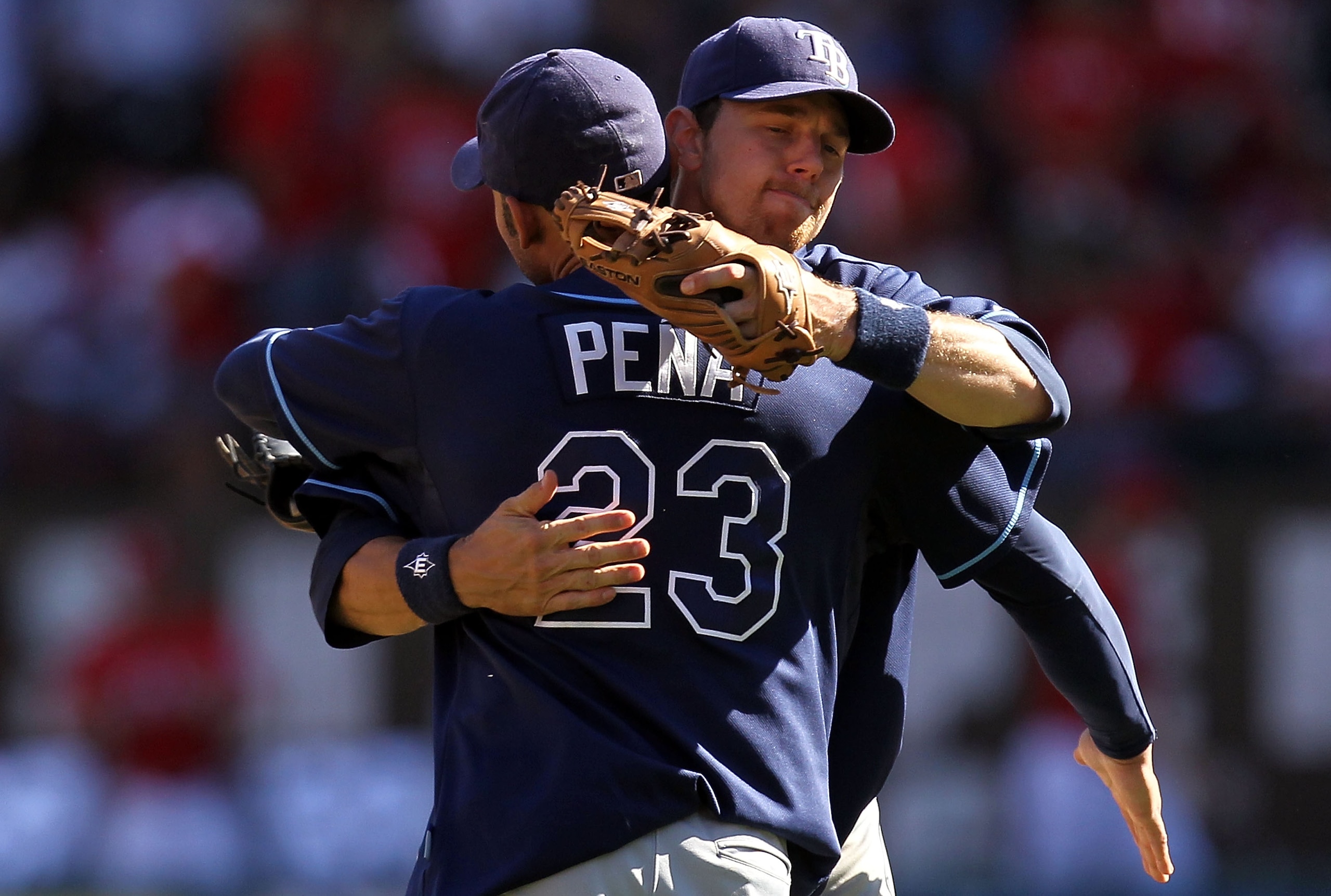 ARLINGTON, TX - OCTOBER 10:  Carlos Pena #23 hugs Ben Zobrist #18 of the Tampa Bay Rays after a 5-2 win against the Texas Rangers during game 4 of the ALDS at Rangers Ballpark in Arlington on October 10, 2010 in Arlington, Texas.  (Photo by Ronald Martine