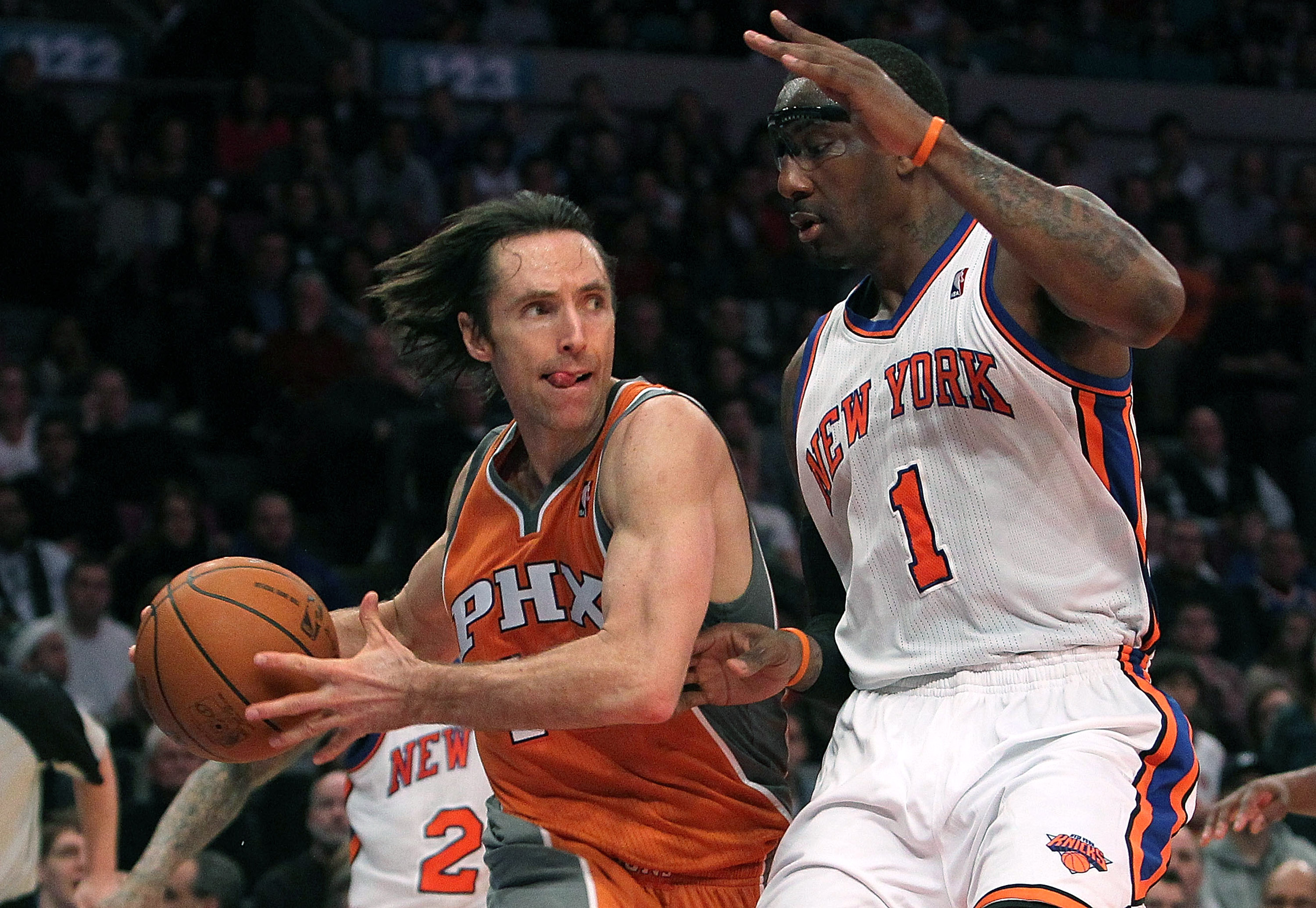 NEW YORK, NY - JANUARY 17:  Steve Nash #13 of the Phoenix Suns drives to the basket against Amar'e Stoudemire #1 of the New York Knicks at Madison Square Garden on January 17, 2011 in New York City. NOTE TO USER: User expressly acknowledges and agrees tha