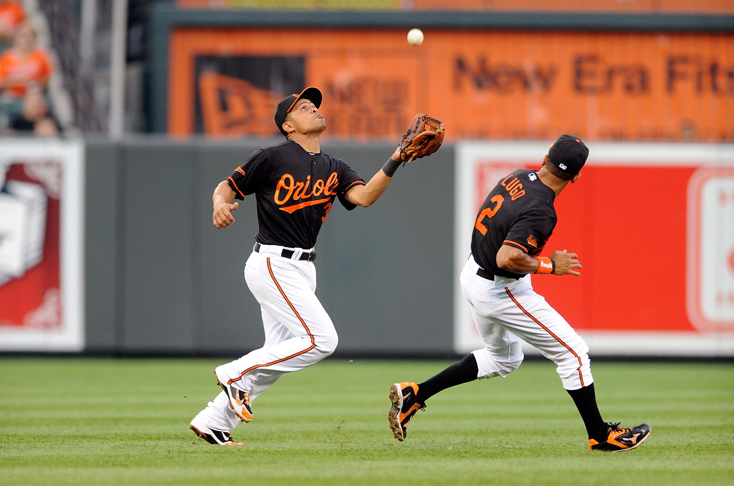 BALTIMORE - JULY 16:  Cesar Izturis #3 of the Baltimore Orioles catches a pop fly in front of Julio Lugo #2 during the game against the Toronto Blue Jays at Camden Yards on July 16, 2010 in Baltimore, Maryland.  (Photo by Greg Fiume/Getty Images)