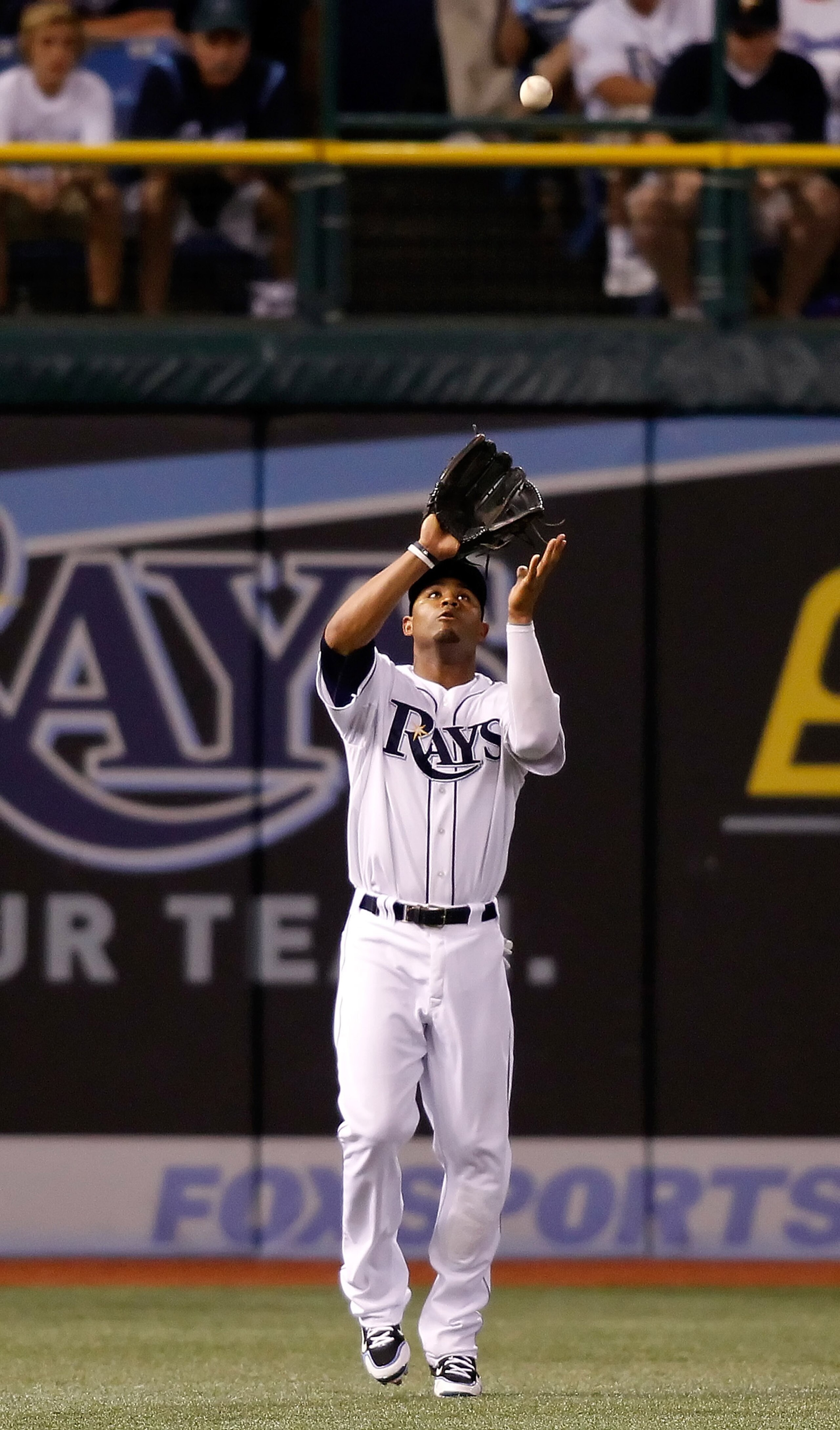ST. PETERSBURG, FL - SEPTEMBER 15:  Outfielder Carl Crawford #13 of the Tampa Bay Rays catches a fly ball against the New York Yankees during the game at Tropicana Field on September 15, 2010 in St. Petersburg, Florida.  (Photo by J. Meric/Getty Images)