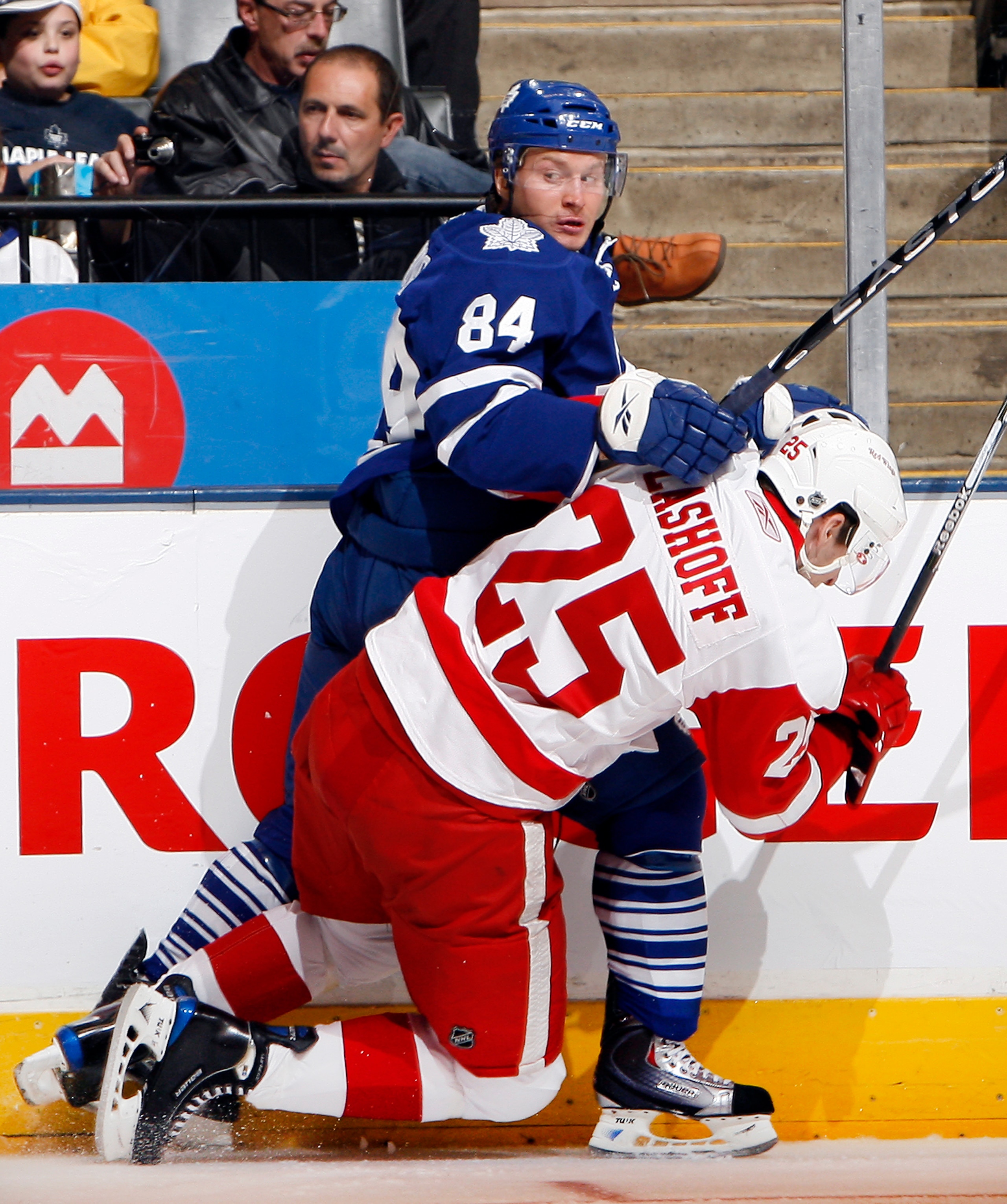 TORONTO - OCTOBER 2: Mikhail Grabovski #84 of the Toronto Maple Leafs keeps the puck from Brian Lashoff #25 of the Detroit Red Wings during a preseason NHL game at the Air Canada Centre October 2, 2010 in Toronto, Ontario, Canada. (Photo by Abelimages/Get