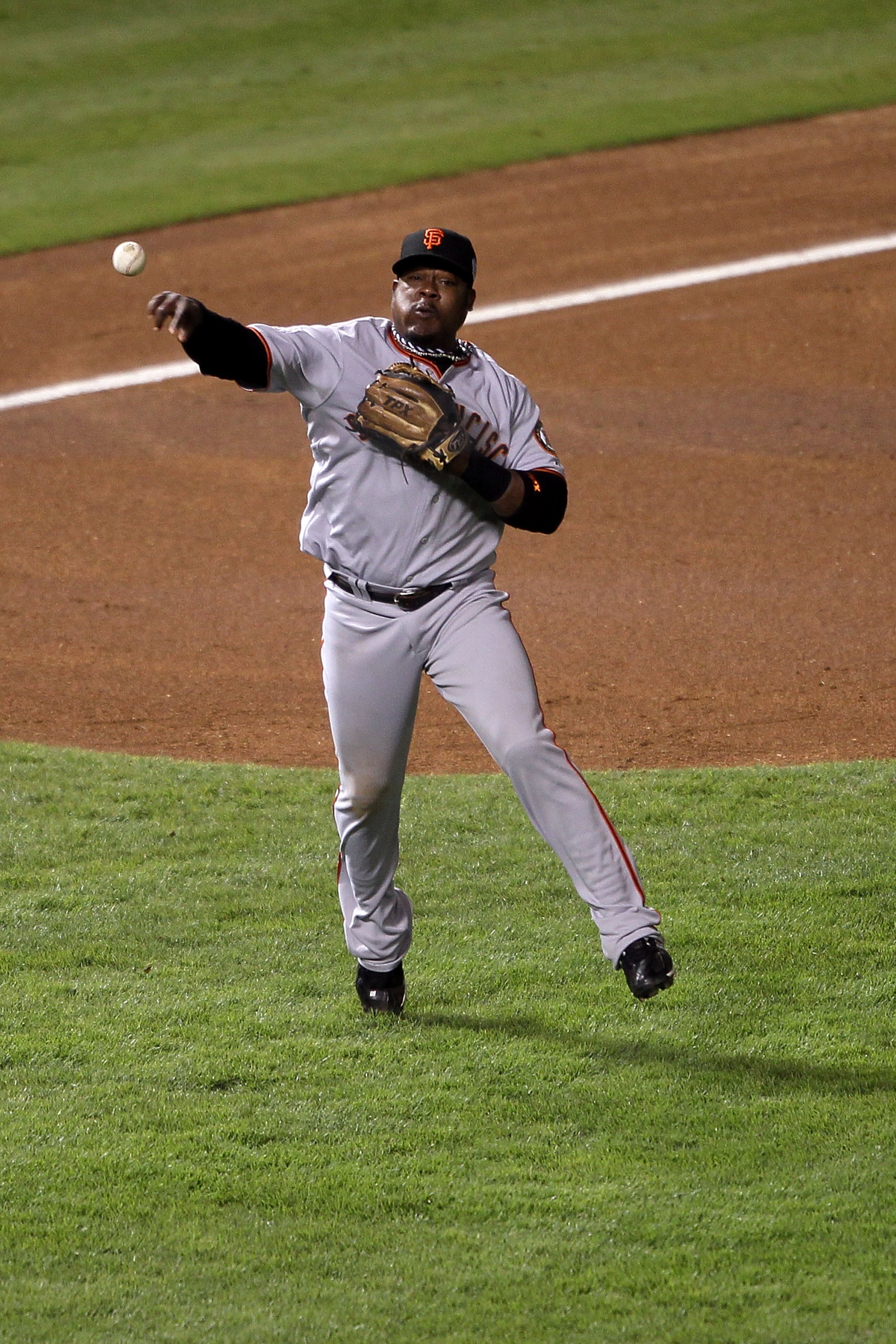 ARLINGTON, TX - NOVEMBER 01:  Juan Uribe #5 of the San Francisco Giants throws the ball to first base against the Texas Rangers in Game Five of the 2010 MLB World Series at Rangers Ballpark in Arlington on November 1, 2010 in Arlington, Texas.  (Photo by