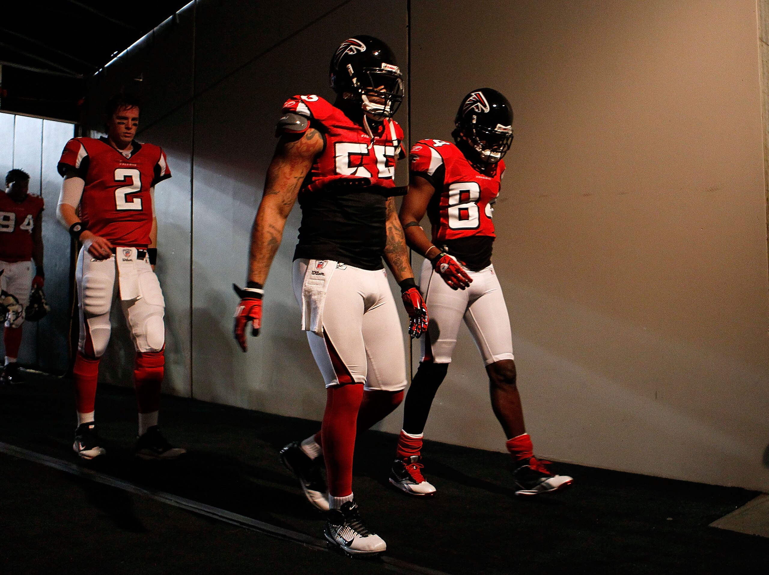 ATLANTA, GA - JANUARY 15: (L-R) Quarterback Matt Ryan #2, John Abraham #55 and Roddy White #84 of the Atlanta Falcons walk to the locker room from the field following warm ups against the Green Bay Packers during their 2011 NFC divisional playoff game at ATLANTA, GA - JANUARY 15: (L-R) Quarterback Matt Ryan #2, John Abraham #55 and Roddy White #84 of the Atlanta Falcons walk to the locker room from the field following warm ups against the Green Bay Packers during their 2011 NFC divisional playoff game at