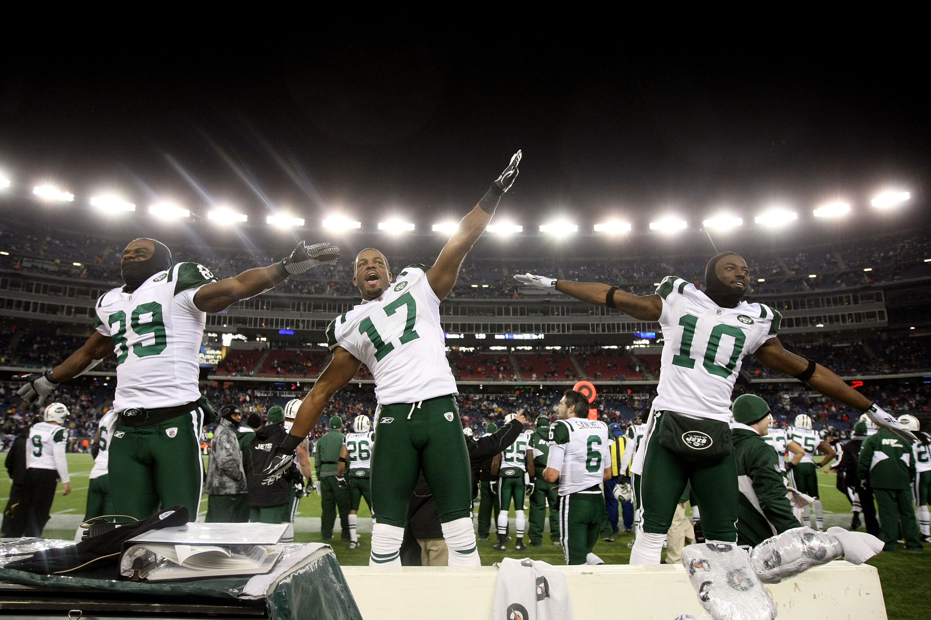 FOXBORO, MA - JANUARY 16:  Jerricho Cotchery #89, Braylon Edwards #17 and Santonio Holmes #10 of the New York Jets celebrate their 28 to 21 victory over the New England Patriots during their 2011 AFC divisional playoff game at Gillette Stadium on January