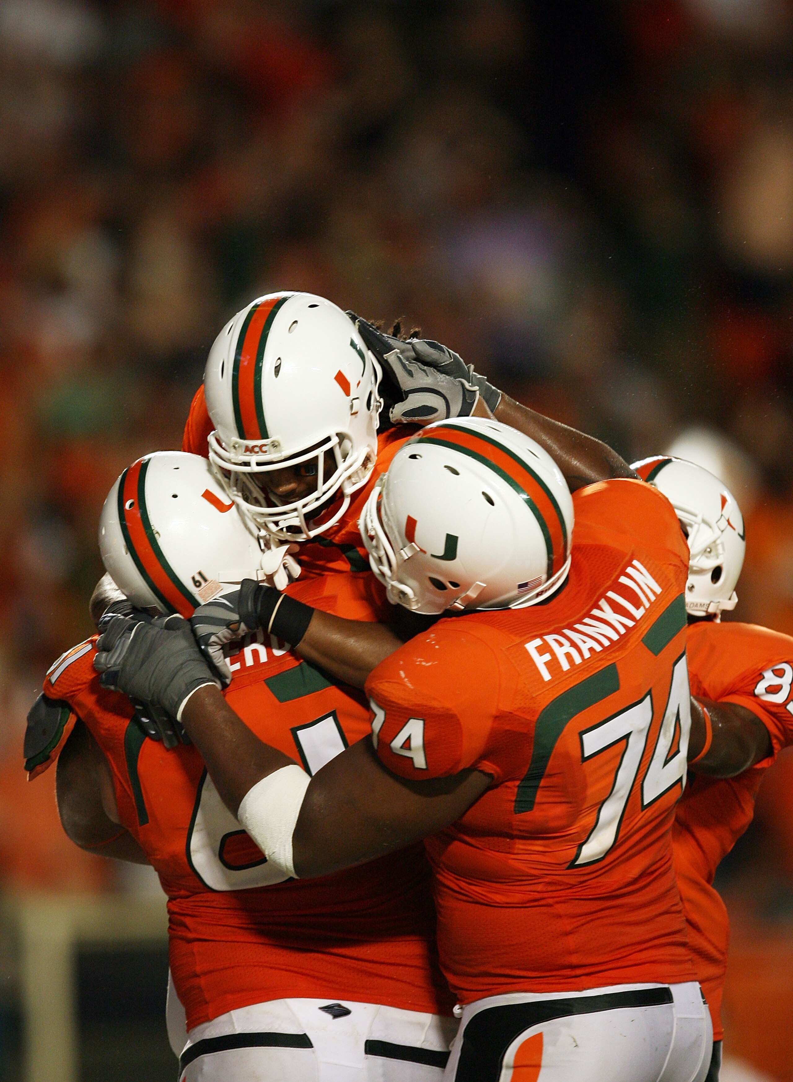 FORT LAUDERDALE, FL - OCTOBER 03: Wide receiver Travis Benjamin #3 of the Miami Hurricanes celebrates his touchdown with teammates Joel Figueroa #61 and Orlando Franklin #74 against the Oklahoma Sooners at Land Shark Stadium on October 3, 2009 in Fort Lau