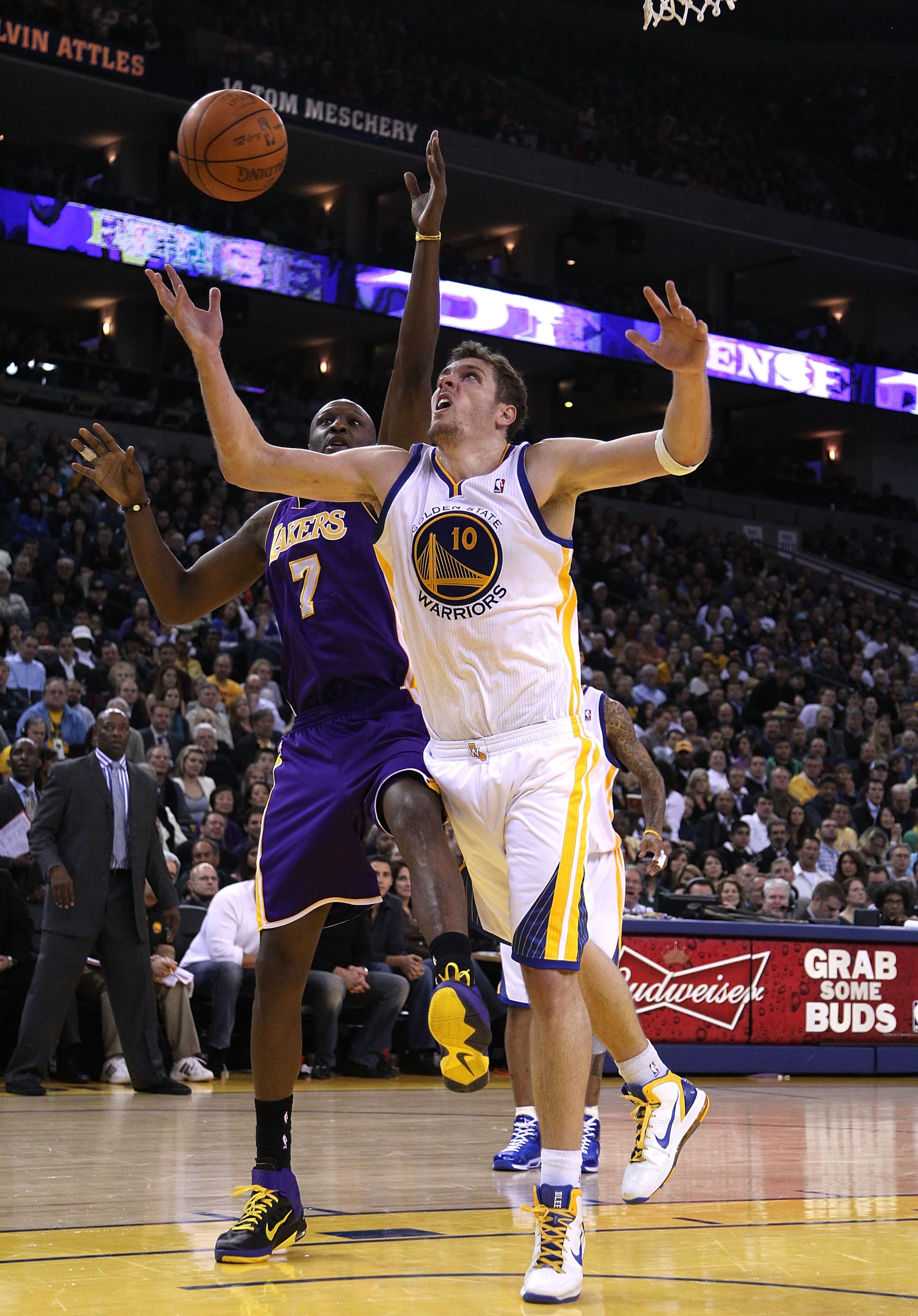 OAKLAND, CA - JANUARY 12: Lamar Odom #7 of the Los Angeles Lakers and David Lee #10 of the Golden State Warriors go for a rebound at Oracle Arena on January 12, 2011 in Oakland, California. NOTE TO USER: User expressly acknowledges and agrees that, by do OAKLAND, CA - JANUARY 12: Lamar Odom #7 of the Los Angeles Lakers and David Lee #10 of the Golden State Warriors go for a rebound at Oracle Arena on January 12, 2011 in Oakland, California. NOTE TO USER: User expressly acknowledges and agrees that, by do