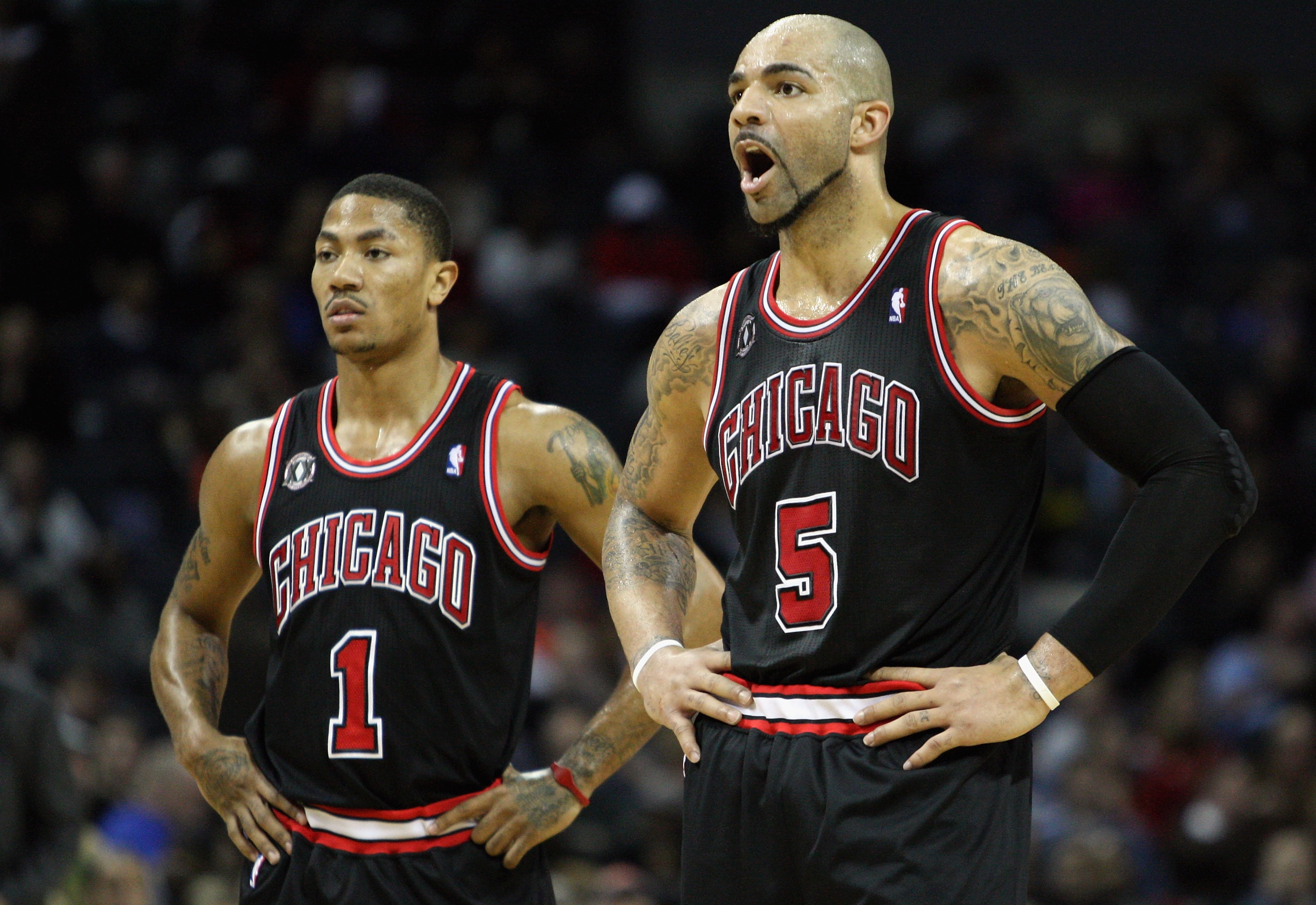 CHARLOTTE, NC - JANUARY 12: Carlos Boozer #5 of the Chicago Bulls yells at a player as his teammate Derrick Rose #1 watches on against the Charlotte Bobcats during their game at Time Warner Cable Arena on January 12, 2011 in Charlotte, North Carolina. NO CHARLOTTE, NC - JANUARY 12: Carlos Boozer #5 of the Chicago Bulls yells at a player as his teammate Derrick Rose #1 watches on against the Charlotte Bobcats during their game at Time Warner Cable Arena on January 12, 2011 in Charlotte, North Carolina. NO
