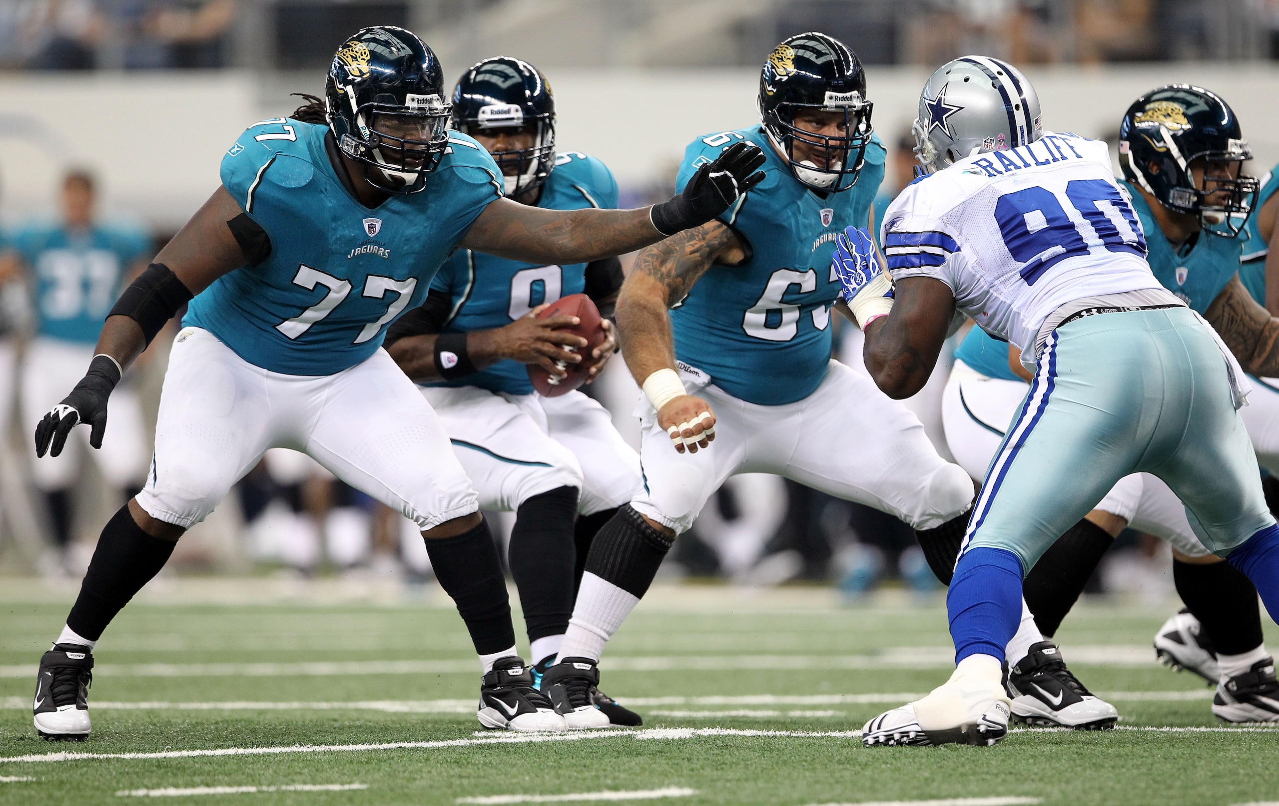 ARLINGTON, TX - OCTOBER 31:  (L-R) Offensive guard Uche Nwaneri #77 and center Brad Meester #63 of the Jacksonville Jaguars pass block against the Dallas Cowboys at Cowboys Stadium on October 31, 2010 in Arlington, Texas.  (Photo by Chris Chambers/Getty I
