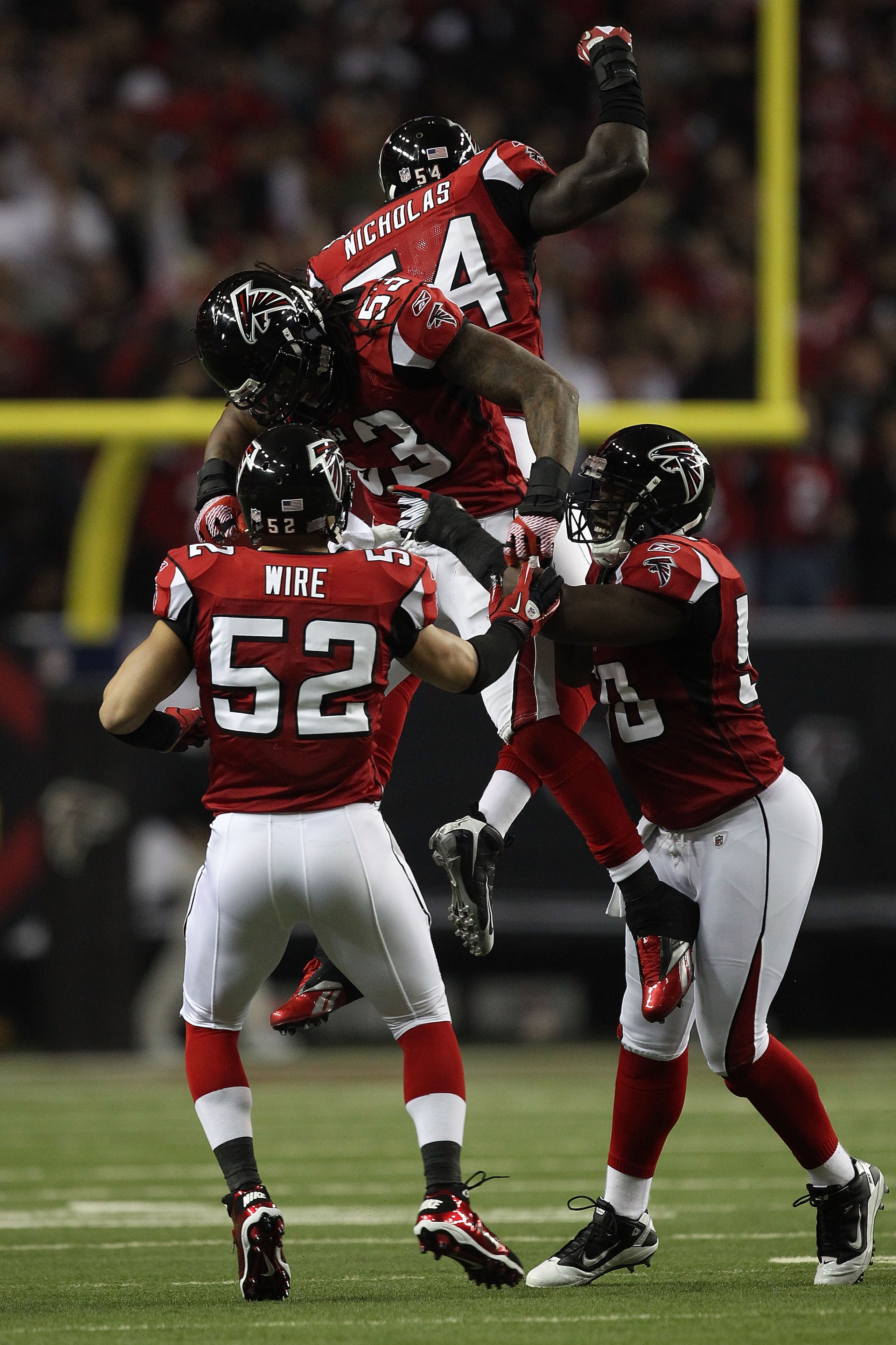 ATLANTA, GA - JANUARY 15: Coy Wire #52, Mike Peterson #53, Stephen Nicholas #54 and Curtis Lofton #50 of the Atlanta Falcons celebrate a defensive play against the Green Bay Packers during their 2011 NFC divisional playoff game at Georgia Dome on January ATLANTA, GA - JANUARY 15: Coy Wire #52, Mike Peterson #53, Stephen Nicholas #54 and Curtis Lofton #50 of the Atlanta Falcons celebrate a defensive play against the Green Bay Packers during their 2011 NFC divisional playoff game at Georgia Dome on January