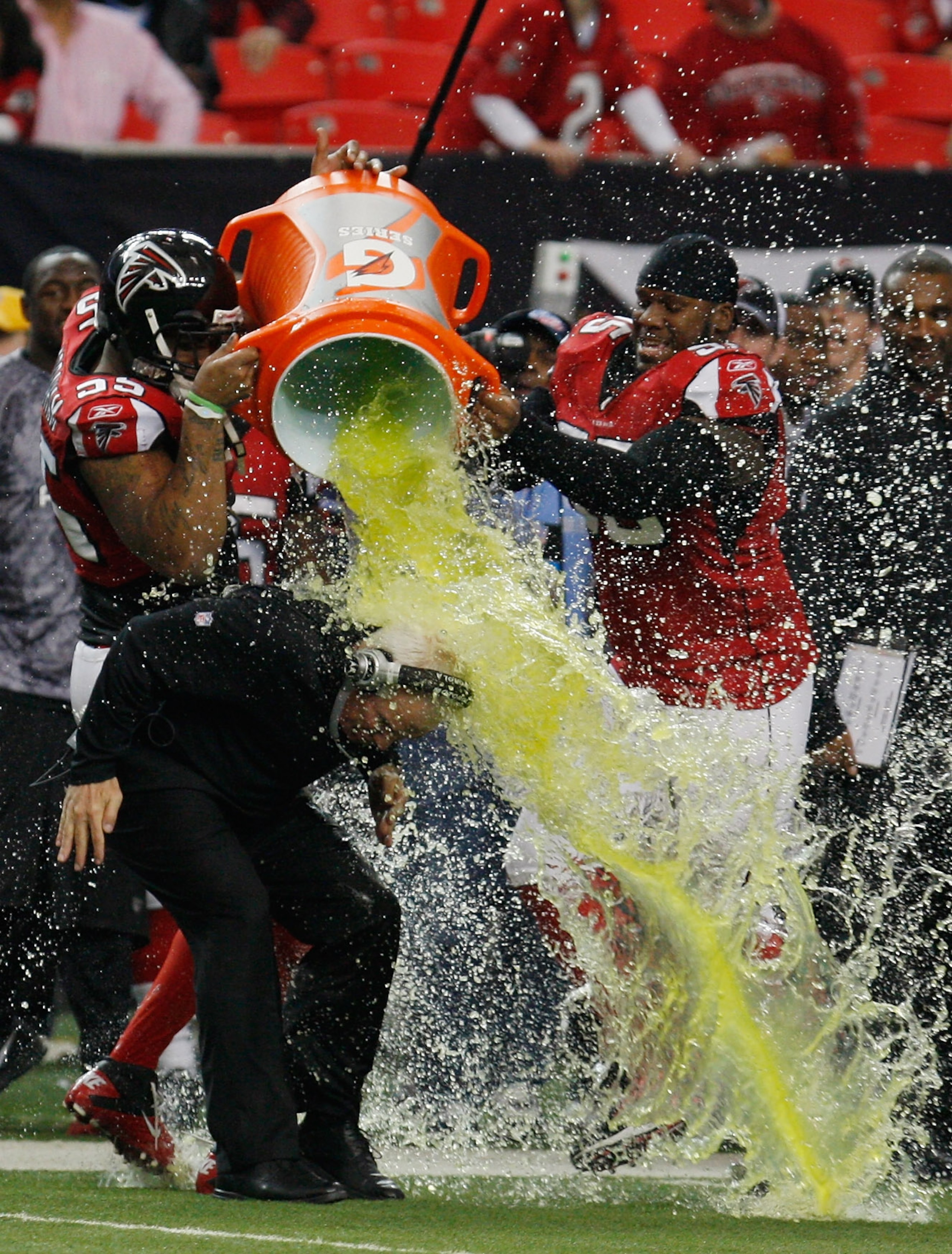 ATLANTA, GA - JANUARY 02: Atlanta Falcons head coach Mike Smith is showered with Gatorade by players John Abraham #55 and Jonathan Babineaux #95 on the sideline during the game against the Carolina Panthers at the Georgia Dome on January 2, 2011 in Atlan ATLANTA, GA - JANUARY 02: Atlanta Falcons head coach Mike Smith is showered with Gatorade by players John Abraham #55 and Jonathan Babineaux #95 on the sideline during the game against the Carolina Panthers at the Georgia Dome on January 2, 2011 in Atlan