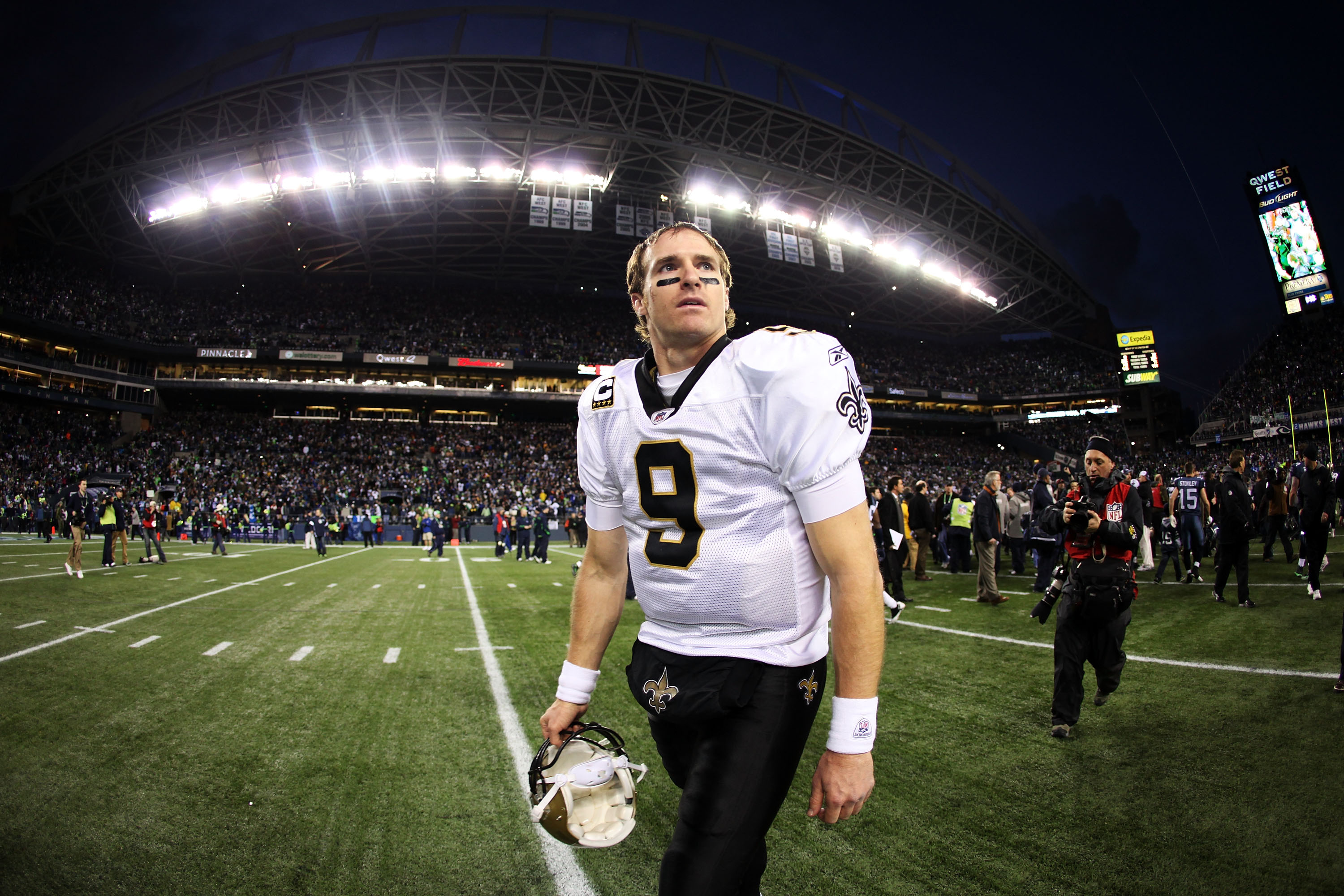 SEATTLE, WA - JANUARY 08:  Quarterback Drew Brees #9 of the New Orleans Saints walks off the field after the Saints were defeated 41-36 by the Seattle Seahawks during the 2011 NFC wild-card playoff game at Qwest Field on January 8, 2011 in Seattle, Washin