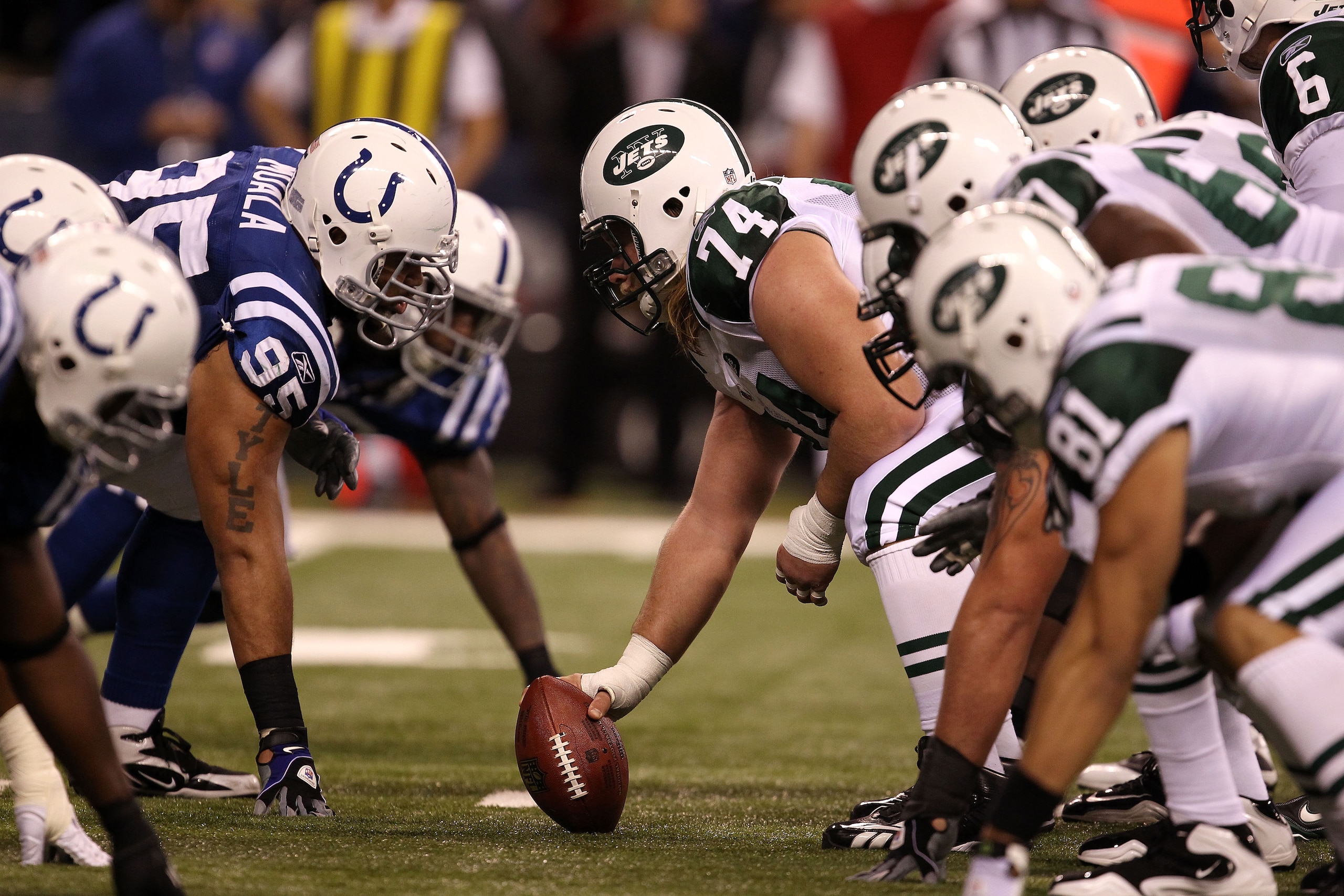 INDIANAPOLIS, IN - JANUARY 08:  Center Nick Mangold #74 of the New York Jets readies the ball for the snap against Fili Moalo #95 of the Indianapolis Colts during their 2011 AFC wild card playoff game at Lucas Oil Stadium on January 8, 2011 in Indianapoli