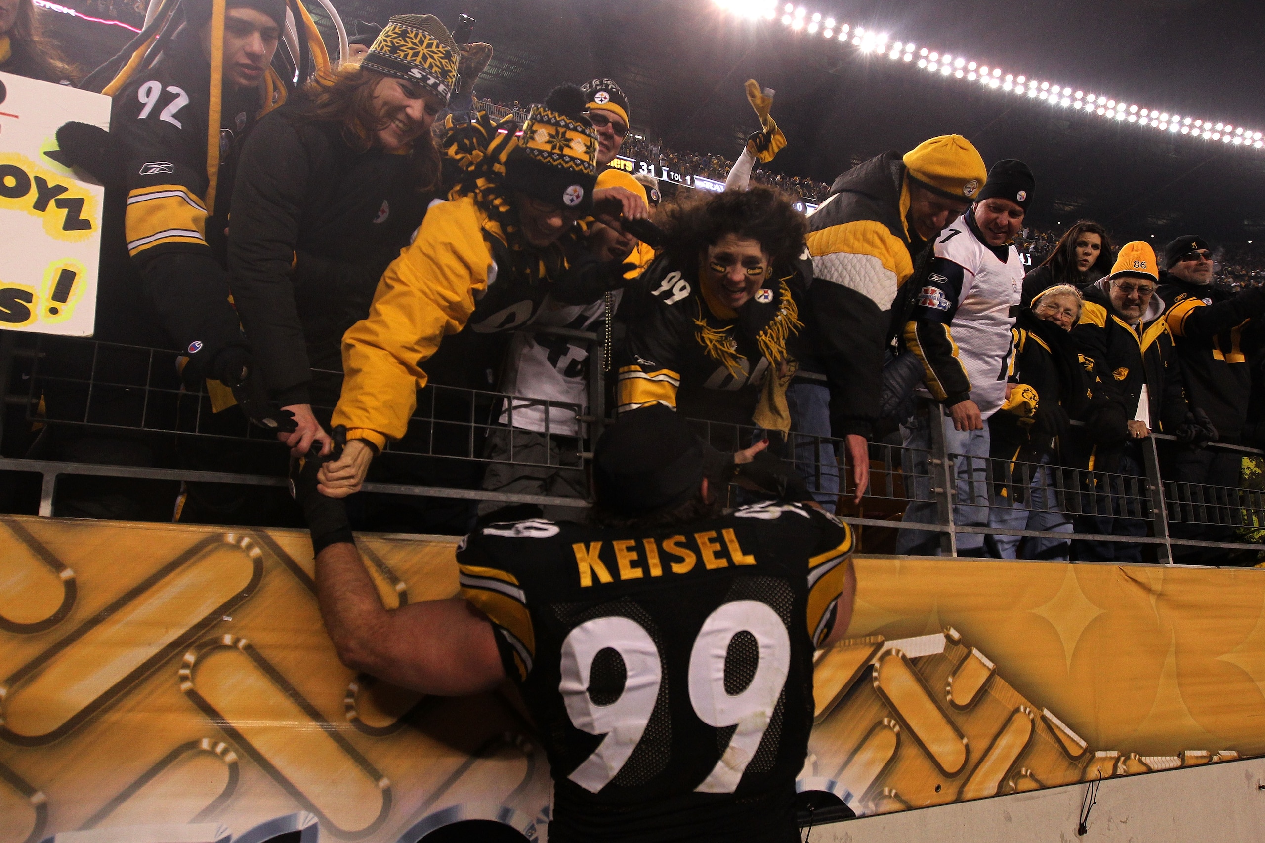 PITTSBURGH, PA - JANUARY 15:  Defensive end Brett Keisel #99 of the Pittsburgh Steelers celebrates with fans after defeating the Baltimore Ravens 31-24 in the AFC Divisional Playoff Game at Heinz Field on January 15, 2011 in Pittsburgh, Pennsylvania.  (Ph