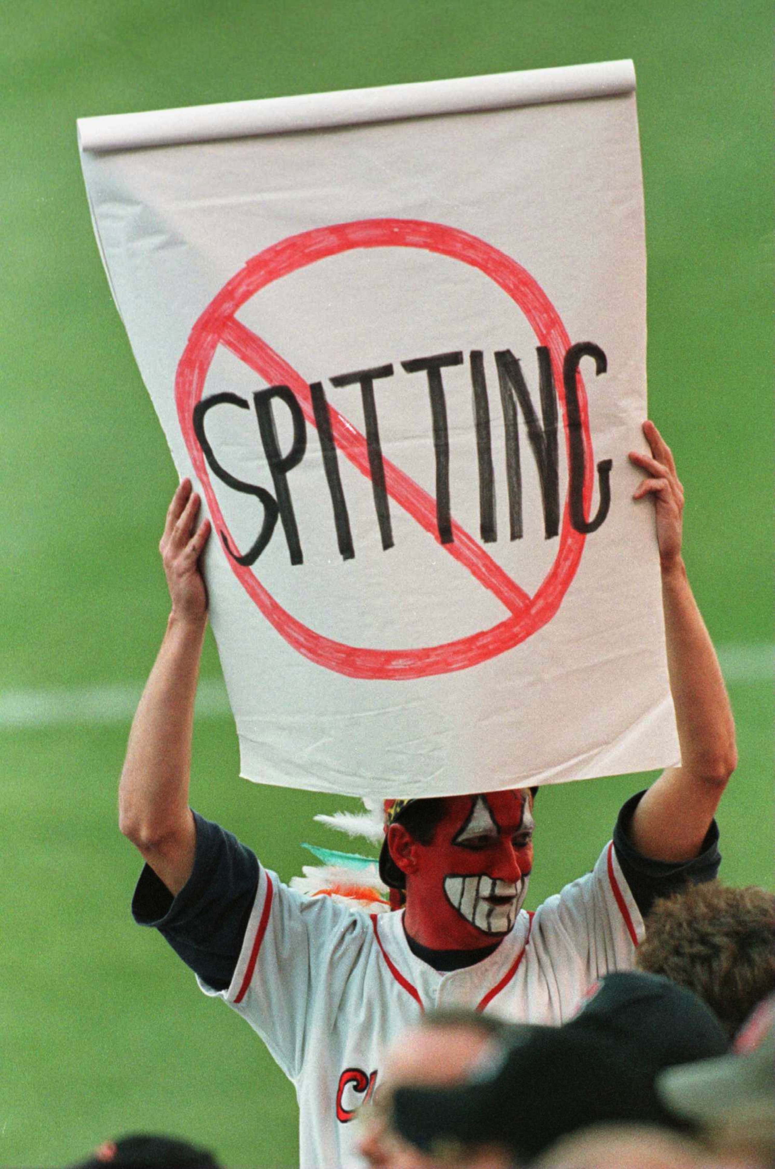 4 Oct 1996: A Cleveland fan displays a no spitting sign, in protest of the Roberto Alomar dispute with the umpire last week, during the third game of the American League Divisional Series at Jacobs Field in Cleveland, Ohio.