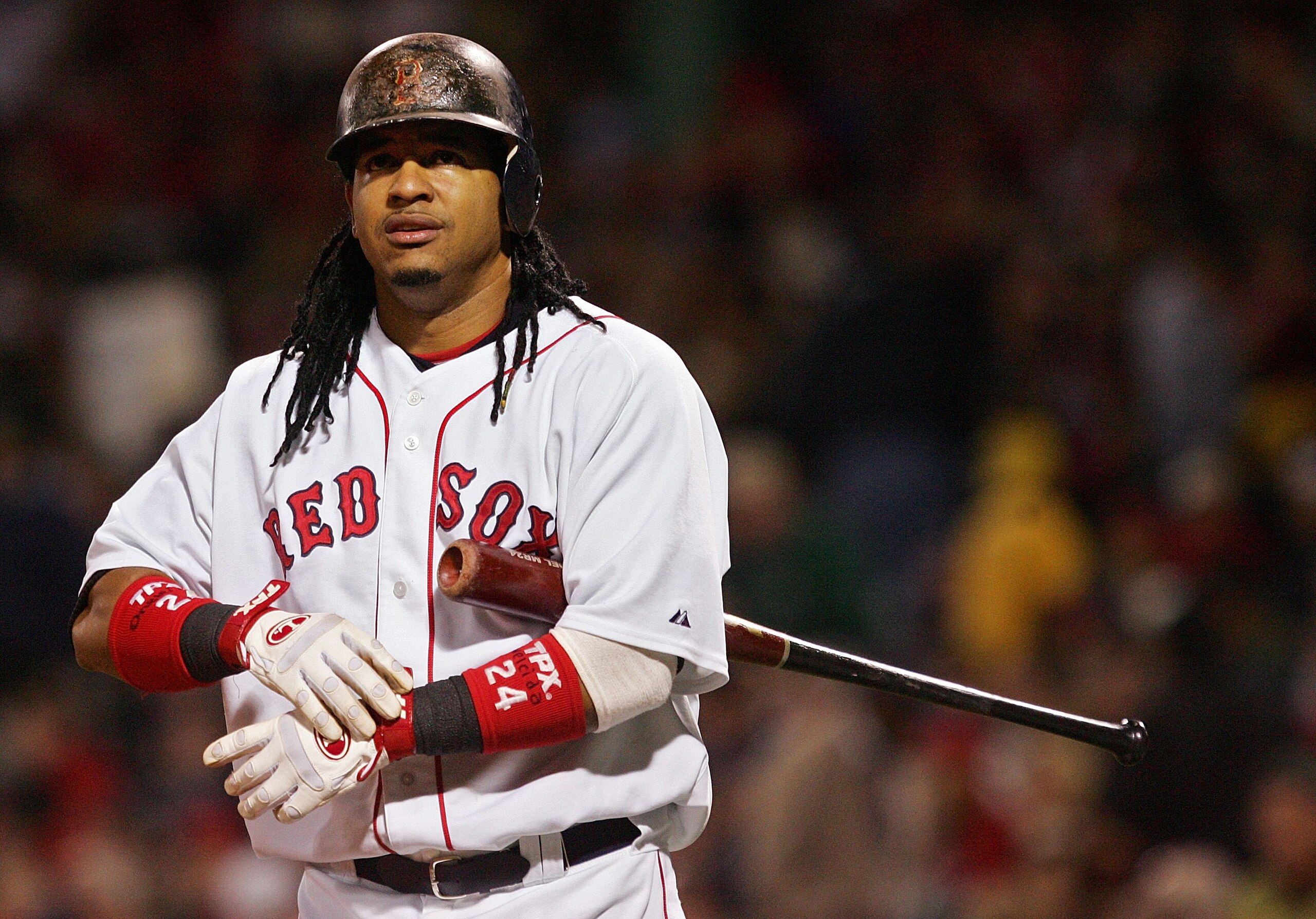 BOSTON - OCTOBER 25:  Manny Ramirez #24 of the Boston Red Sox adjusts his glove during Game Two of the 2007 Major League Baseball World Series against the Colorado Rockies at Fenway Park on October 25, 2007 in Boston, Massachusetts.  (Photo by Jim McIsaac