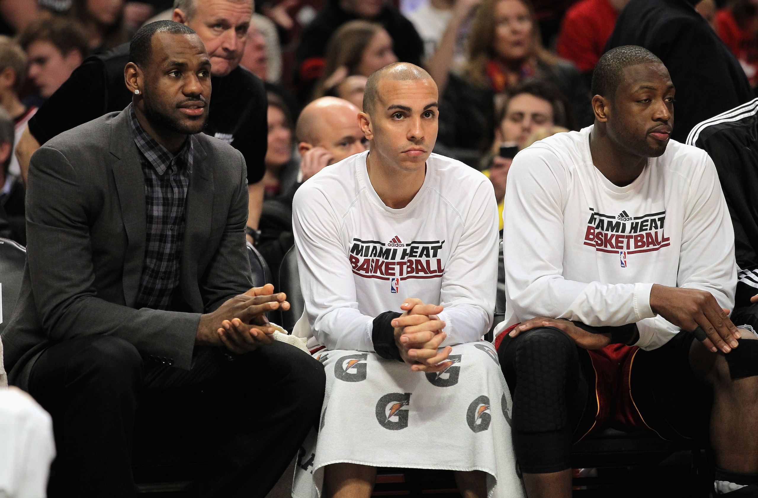 CHICAGO, IL - JANUARY 15:  (L-R) LeBron James #6, Carlos Arroyo #8 and Dwyane Wade #3 of the Miami Heat sit on the bench in the fourth quarter against the Chicago Bulls at the United Center on January 15, 2011 in Chicago, Illinois. James missed the game w