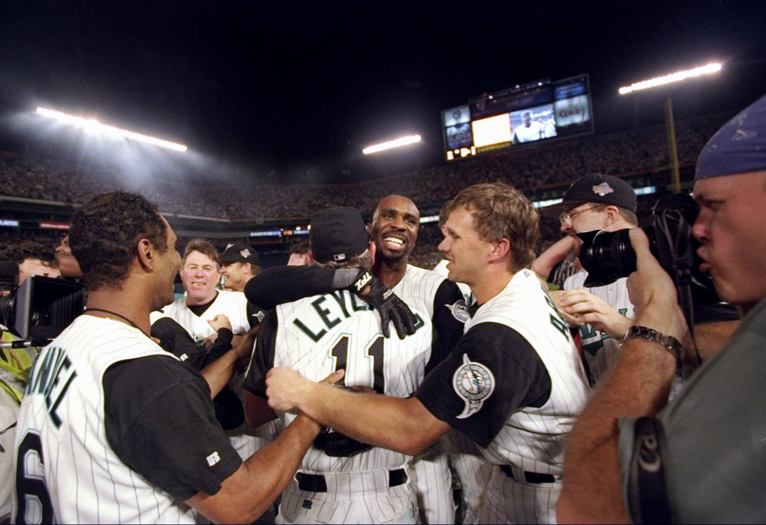 26 Oct 1997:   Outfielder Devon White of the Florida Marlins hugs manager Jim Leyland as other teammates celebrate after 11 innings of the 7th game of the World Series against the Cleveland Indians at Pro Player Stadium in Miami, Florida.  The Marlins won