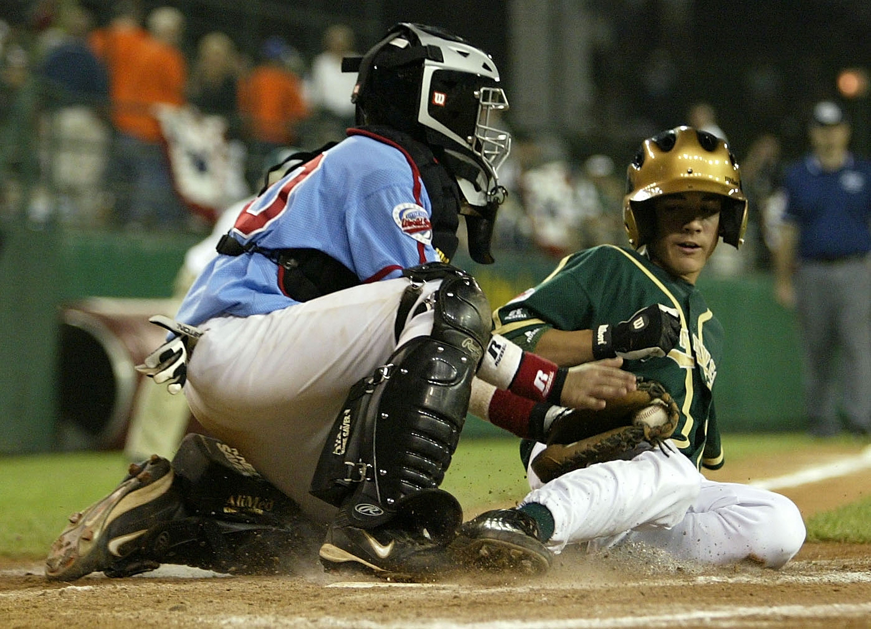 SOUTH WILLIAMSPORT, PA - AUGUST 25:  Randal Grichuk of Texas is tagged out at home by Chris Fine #20 of North Carolina during the United States Semifinal Game in the Little League World Series on August 25, 2004 at Lamade Stadium in South Williamsport, Pe
