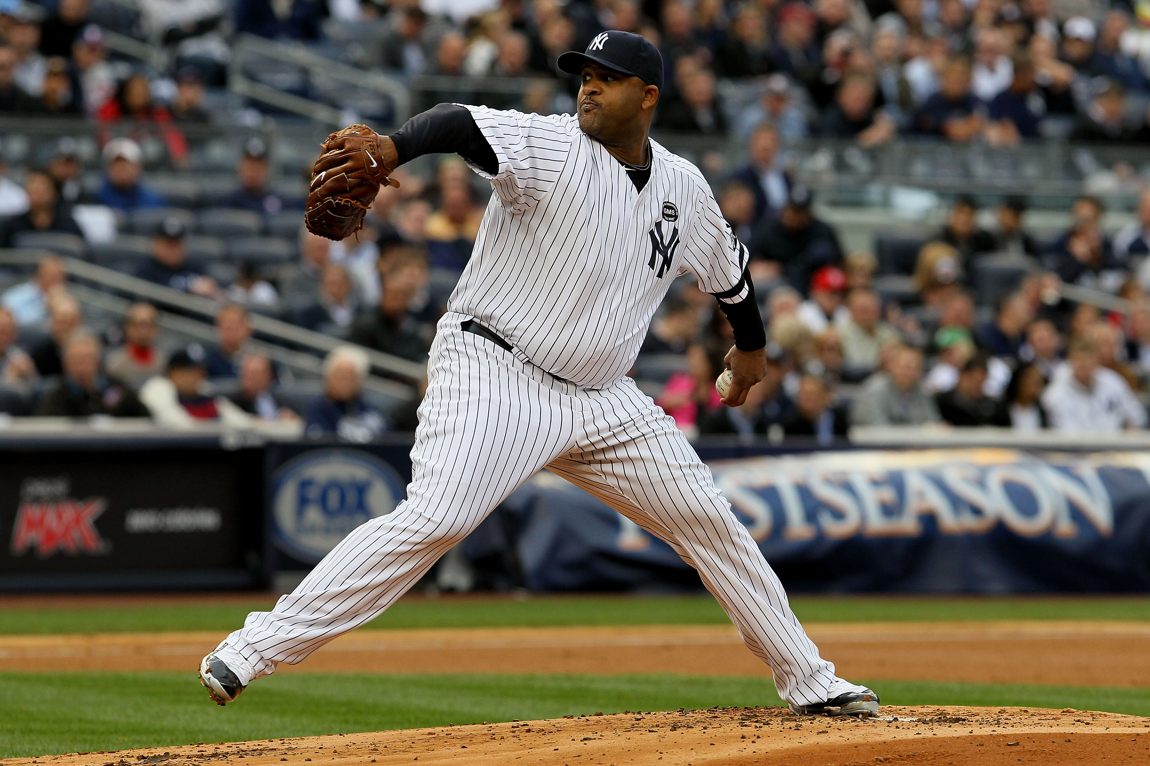 NEW YORK - OCTOBER 20:  CC Sabathia #52 of the New York Yankees pitches against the Texas Rangers in Game Five of the ALCS during the 2010 MLB Playoffs at Yankee Stadium on October 20, 2010 in the Bronx borough of New York City.  (Photo by Jim McIsaac/Get
