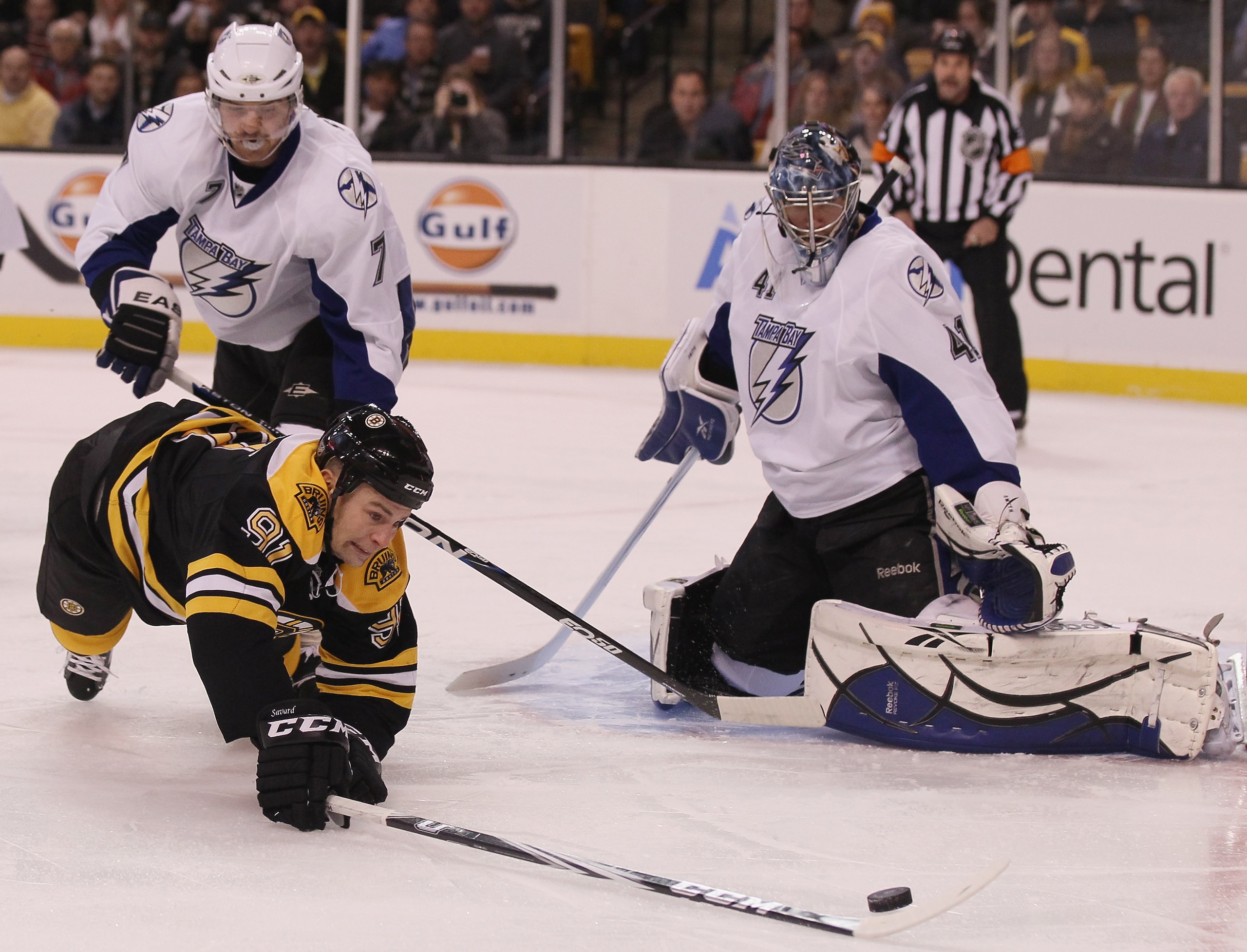 BOSTON, MA - DECEMBER 02:  Marc Savard #91 of the Boston Bruins tries to get a shot past Mike Smith #41 of the Tampa Bay Lightning as Brett Clark #7 of the Lightning defends on December 2, 2010 at the TD Garden in Boston, Massachusetts.  (Photo by Elsa/Ge