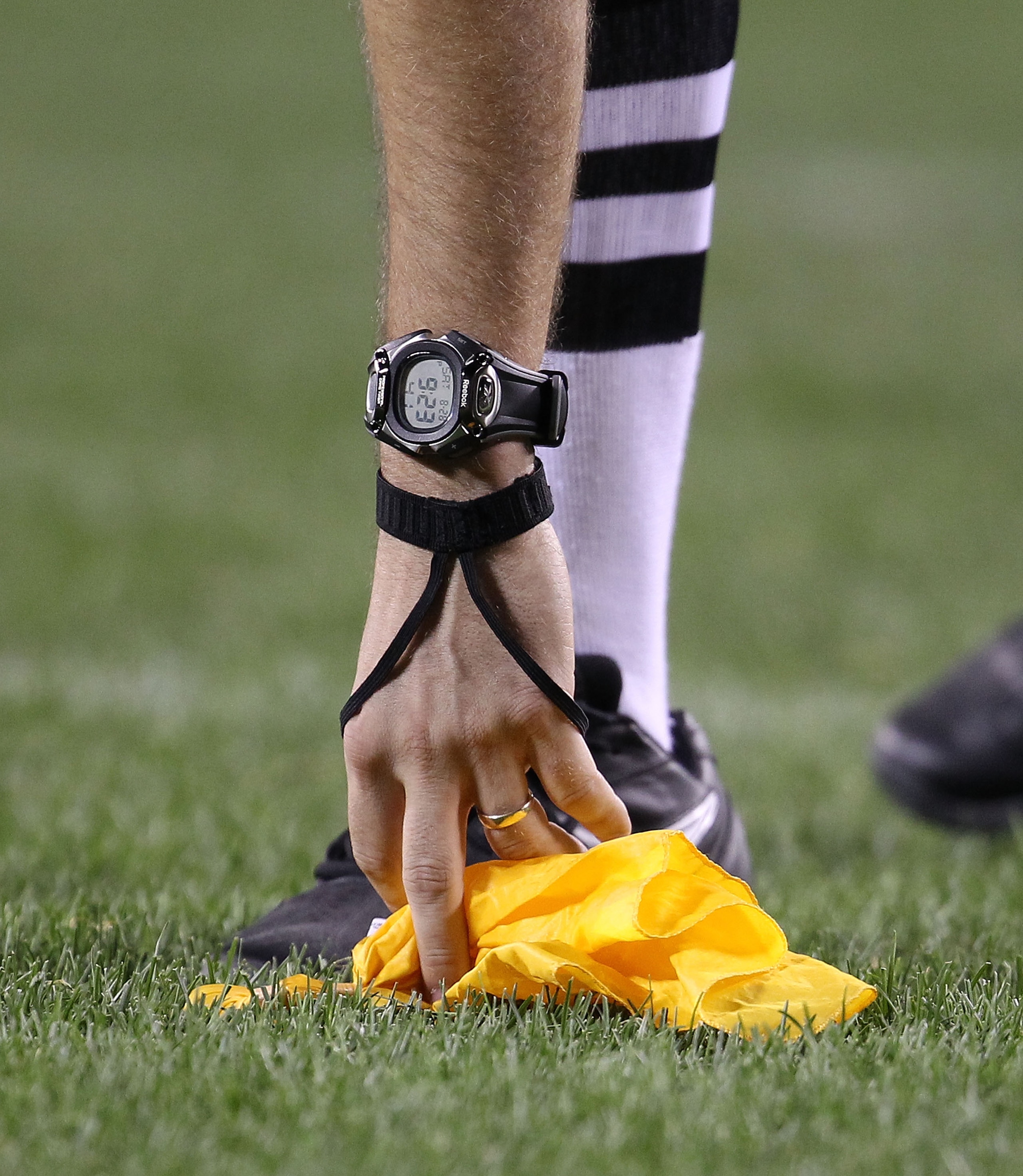 CHICAGO - AUGUST 28: A referee picks up a penalty flag during a preseason game between the Chicago Bears and the Arizona Cardinals during a preseason game at Soldier Field on August 28, 2010 in Chicago, Illinois. The Cardinals defeated the Bears 14-9. (Ph