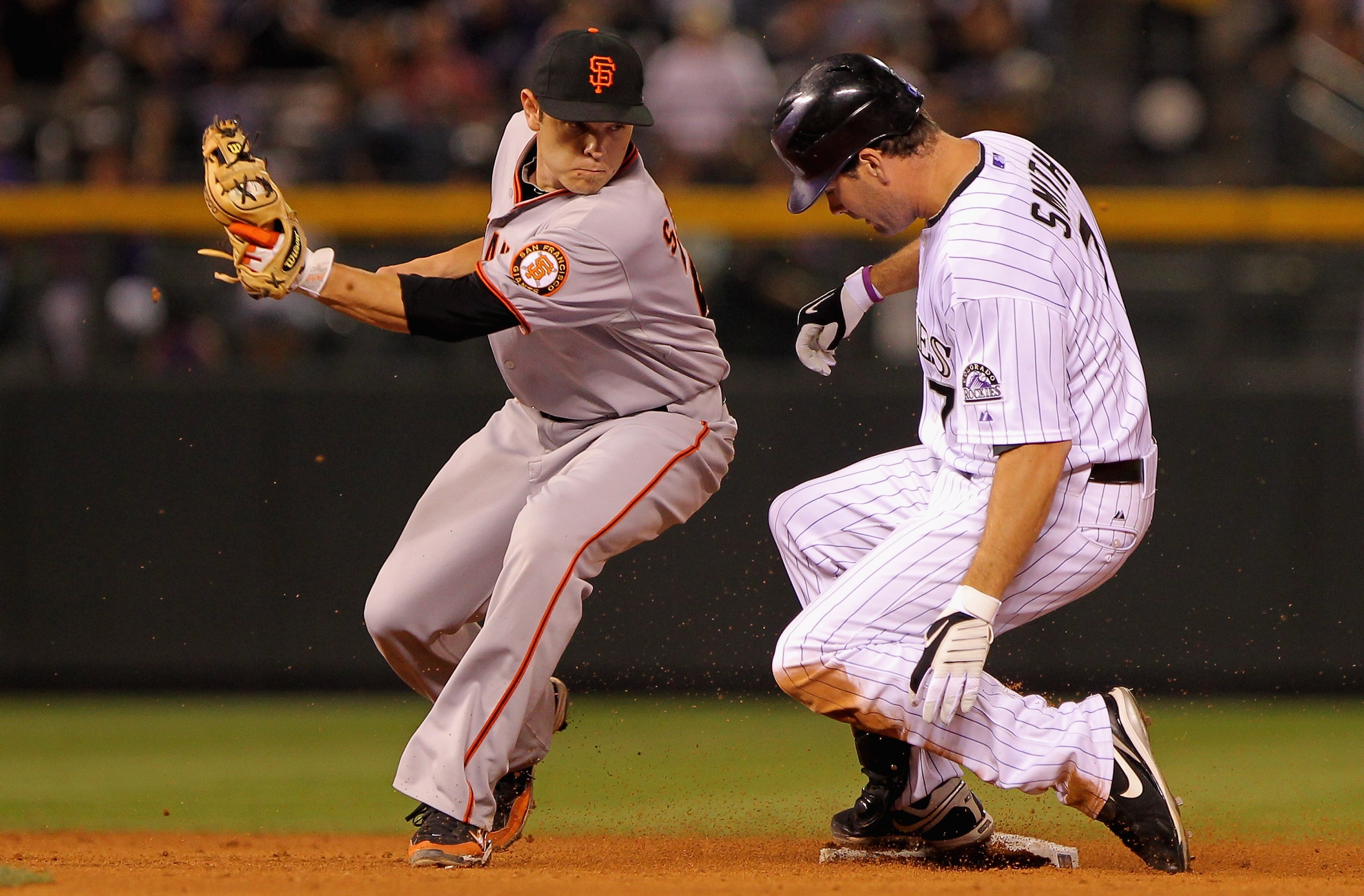 DENVER - SEPTEMBER 24:  Seth Smith #7 of the Colorado Rockies slides into second base ahead of the tag by second baseman Freddy Sanchez #21 of the San Francisco Giants in the sixth inning at Coors Field on September 24, 2010 in Denver, Colorado. Smith wen