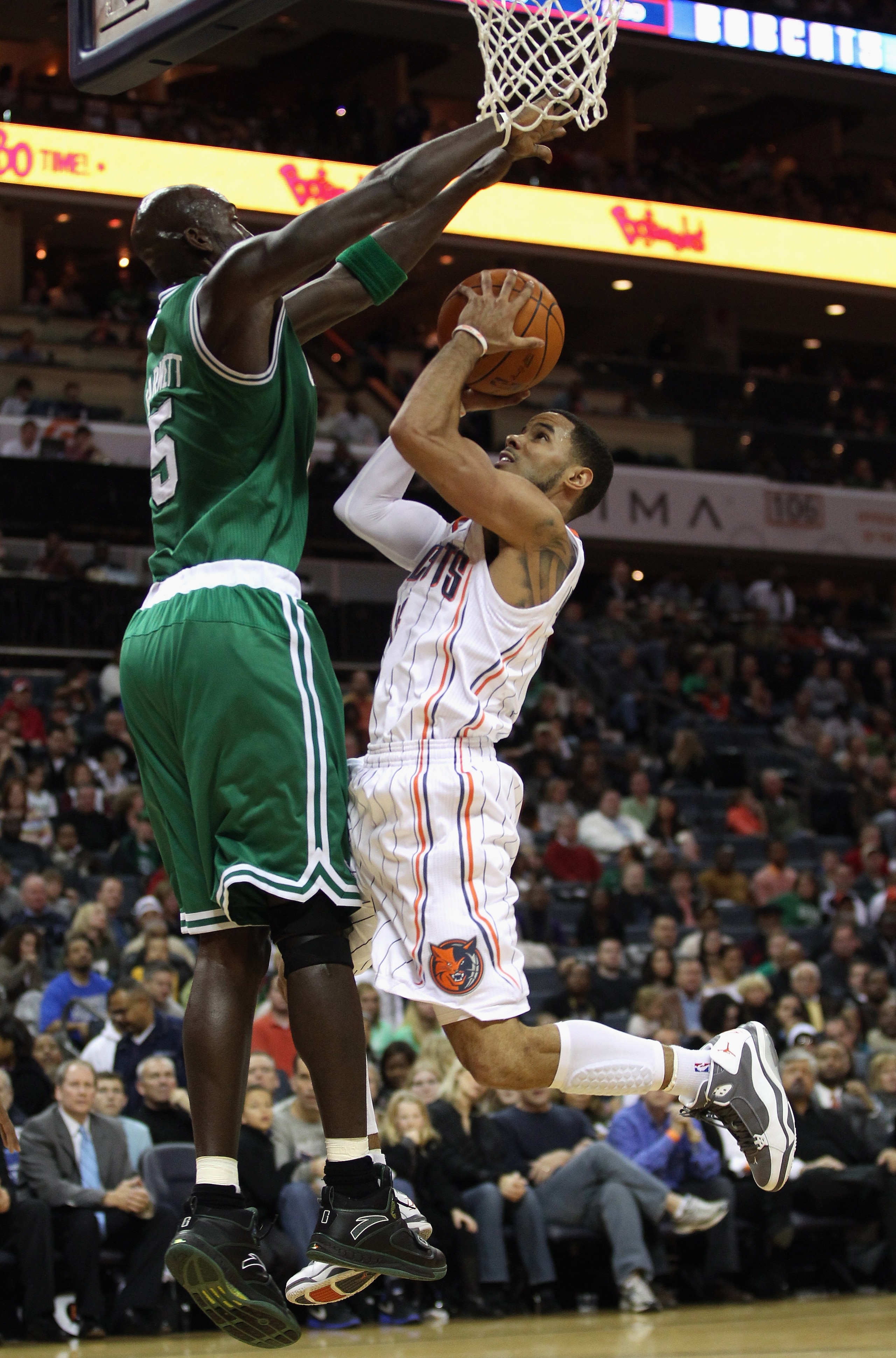 CHARLOTTE, NC - DECEMBER 11:  Kevin Garnett #5 of the Boston Celtics tries to stop D.J. Augustin #14 of the Charlotte Bobcats during their game at Time Warner Cable Arena on December 11, 2010 in Charlotte, North Carolina. NOTE TO USER: User expressly ackn