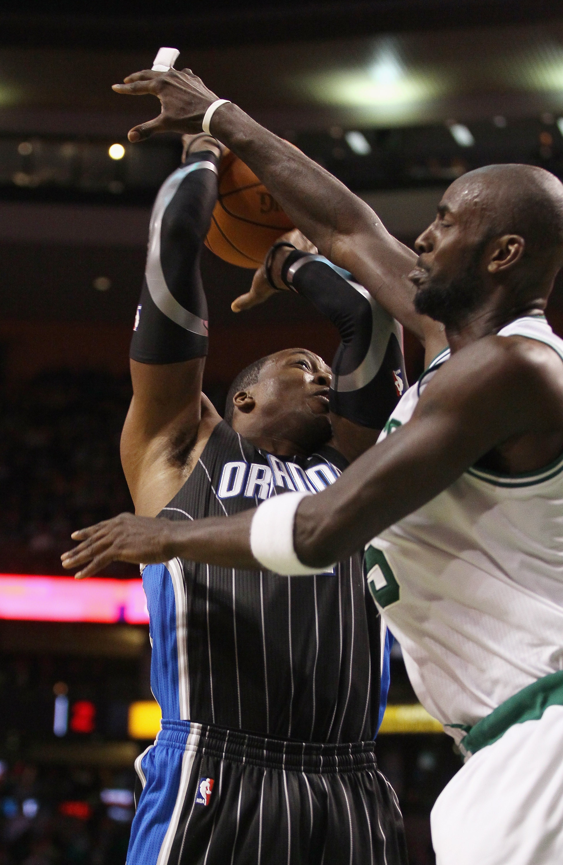 BOSTON, MA - JANUARY 17:  Dwight Howard #12 of the Orlando Magic is fouled by Kevin Garnett #5 of the Boston Celtics  on January 17, 2011 at the TD Garden in Boston, Massachusetts. The Celtics defeated the Magic 109-106.  NOTE TO USER: User expressly ackn