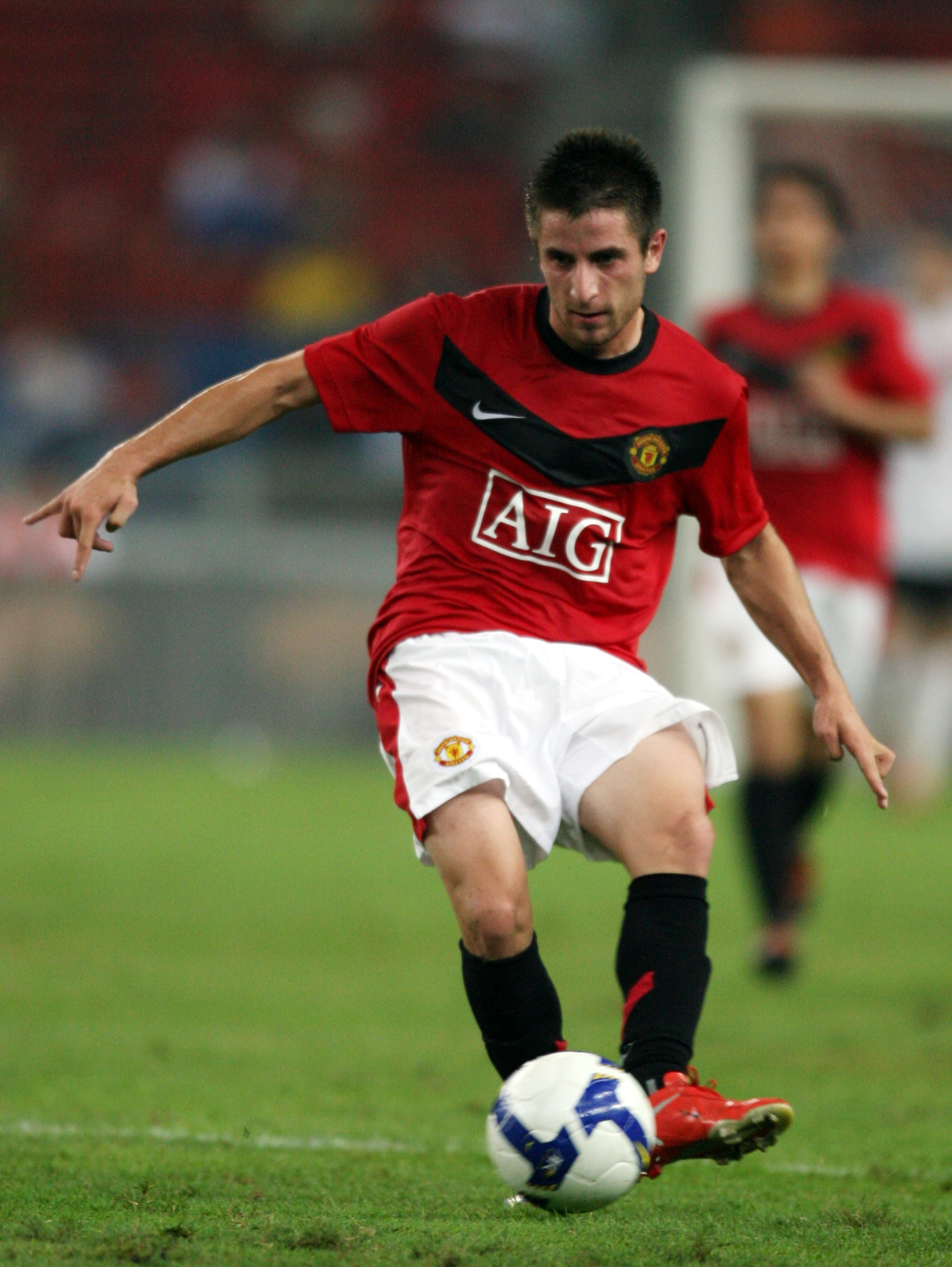 KUALA LUMPUR, MALAYSIA - JULY 20: Zoran Tosic of Manchester United passes the ball during the pre-season friendly match between Manchester United and Malaysia XI at Bukit Jalil National Stadium on July 20, 2009 in Kuala Lumpur, Malaysia. (Photo by Stanley