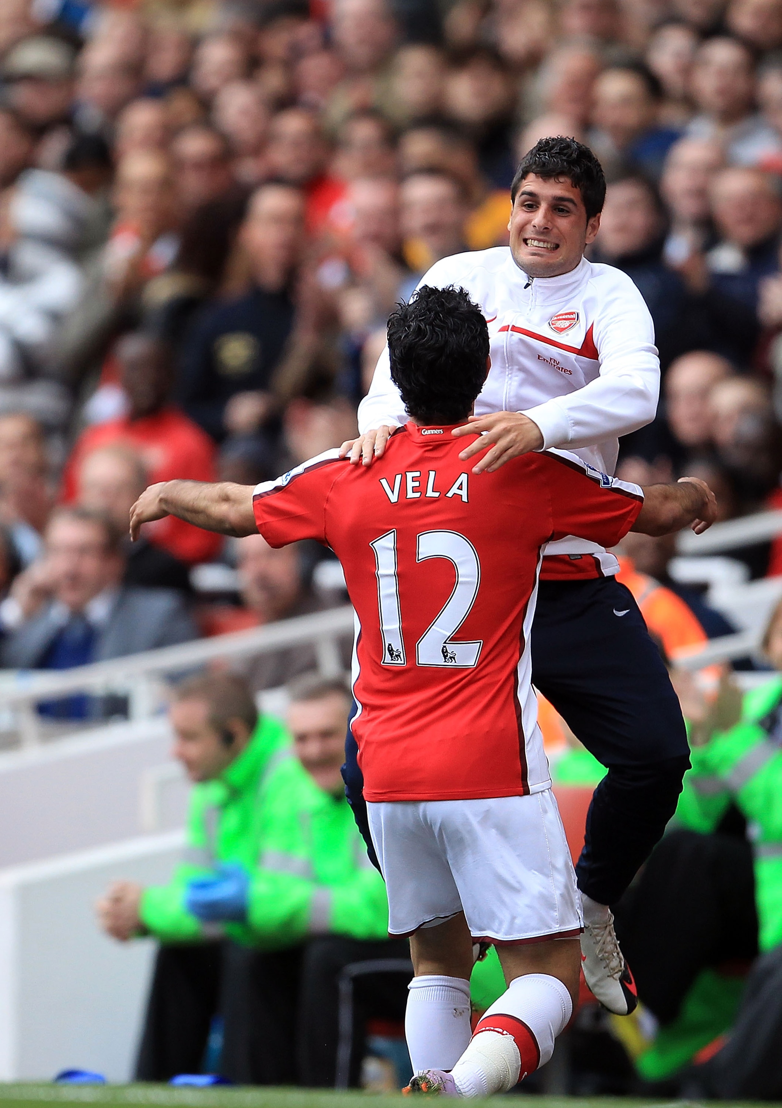 LONDON, ENGLAND - MAY 09: Carlos Vela of Arsenal races to celebrate with team-mate Fran Merida after Vela scored Arsenal's 4:0 goal during the Barclays Premier League match between Arsenal and Fulham at The Emirates Stadium on May 9, 2010 in London, Engla