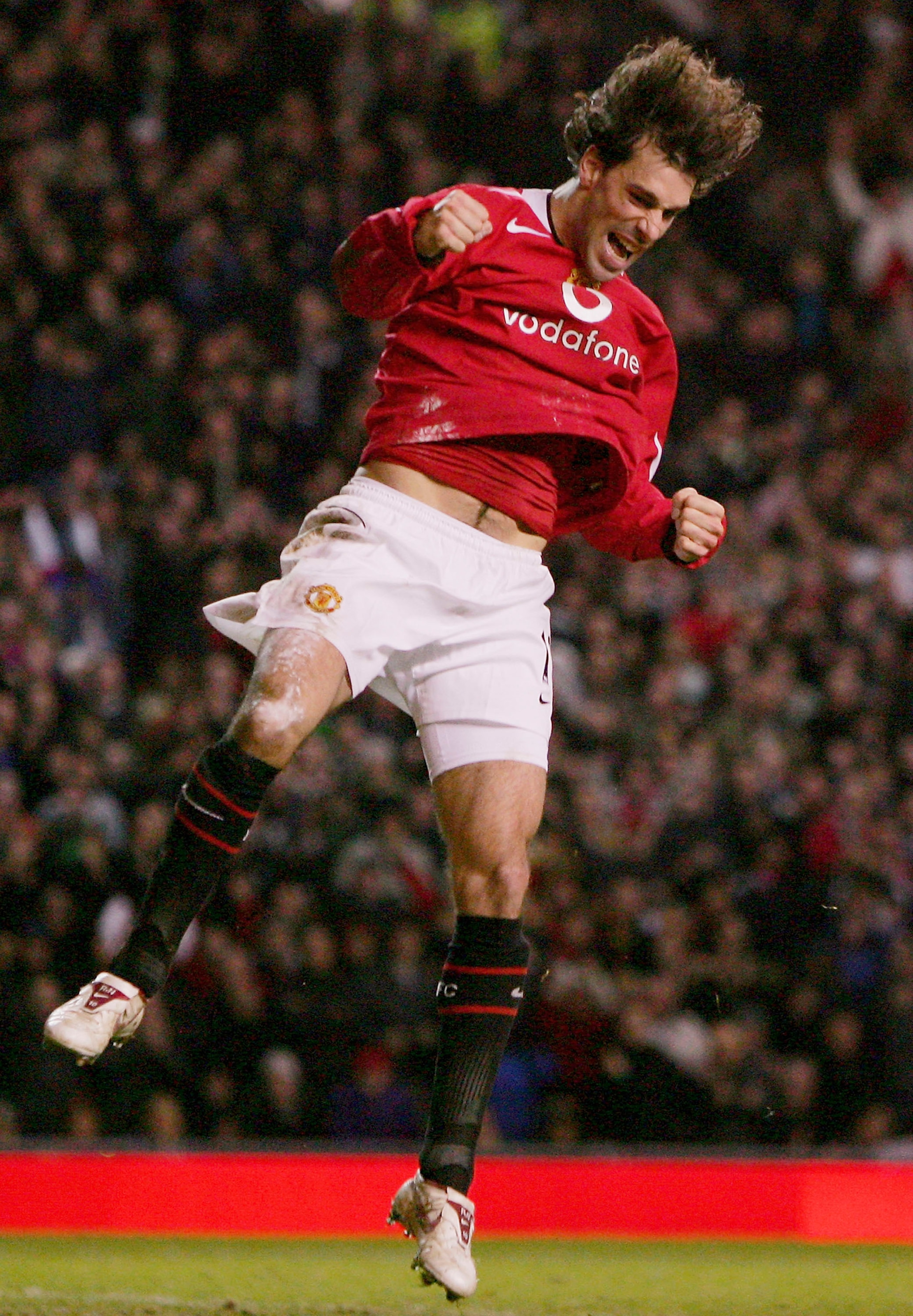 MANCHESTER, UNITED KINGDOM - DECEMBER 14: Ruud van Nistelrooy of Manchester United celebrates scoring the fourth goal during the FA Barclays Premiership match between Manchester United and Wigan Athletic at Old Trafford on December 14, 2005 in Manchester,