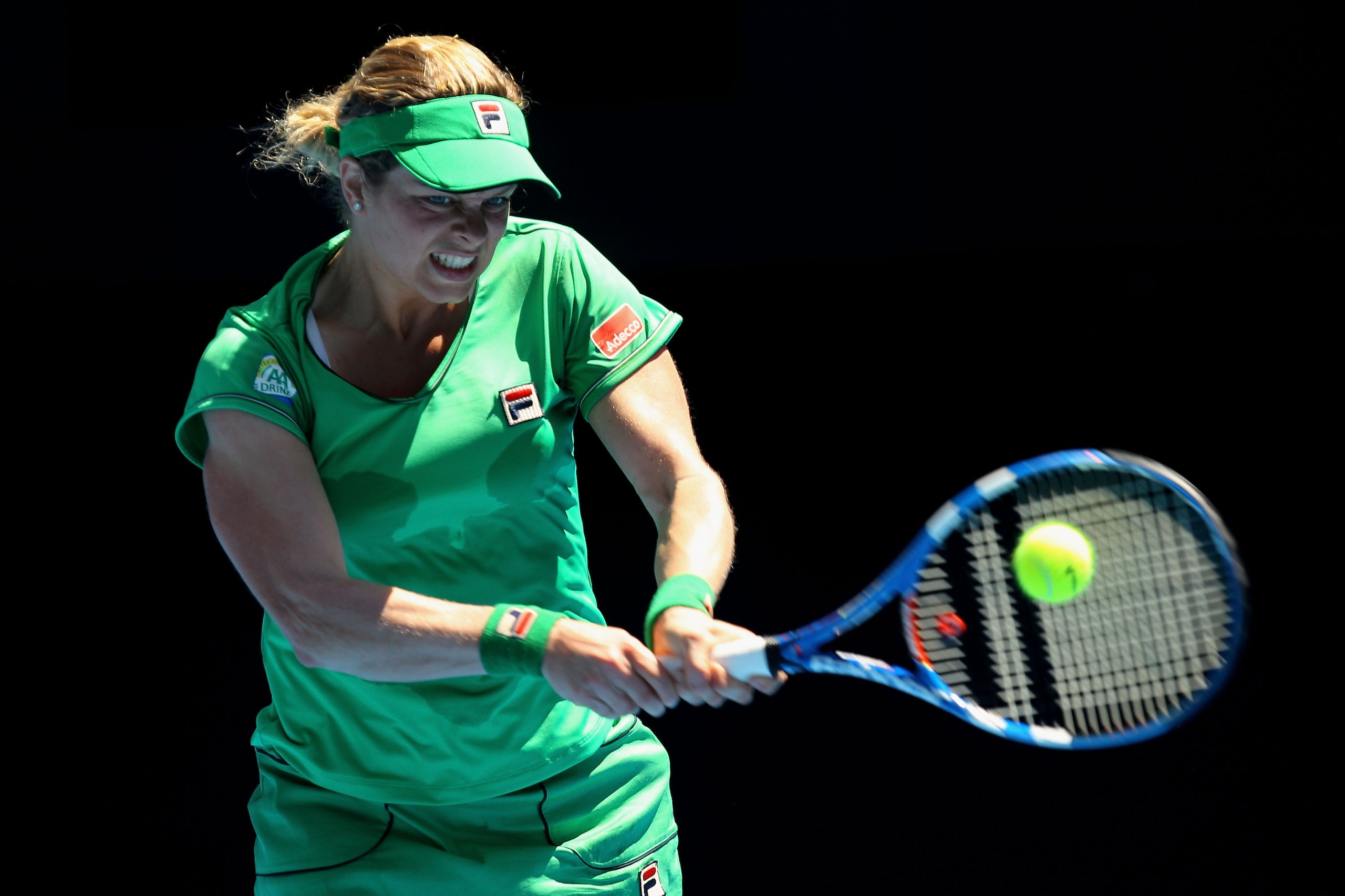 MELBOURNE, AUSTRALIA - JANUARY 20:  Kim Clijsters of Belgium plays a backhand in her second round match against Carla Suarez Navarro of Spain during day four of the 2011 Australian Open at Melbourne Park on January 20, 2011 in Melbourne, Australia.  (Phot