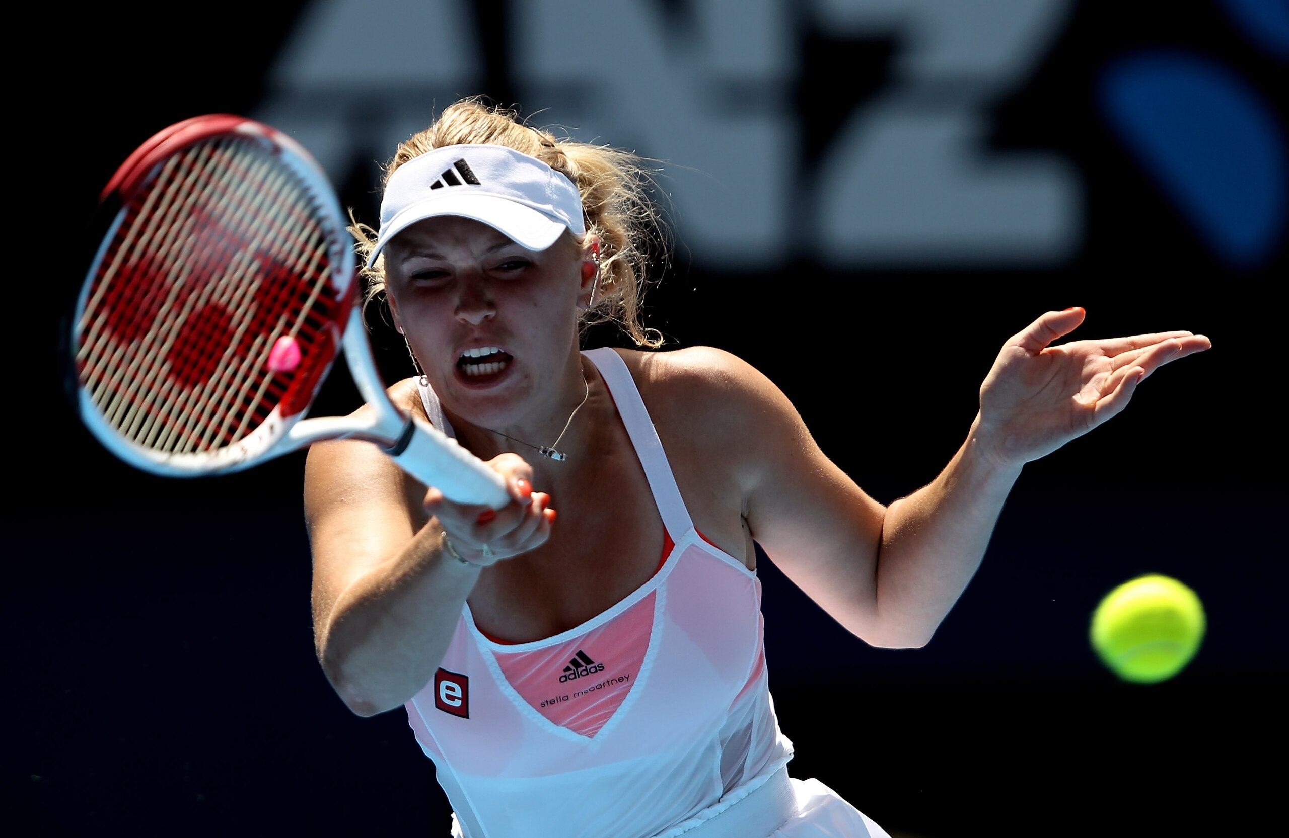 MELBOURNE, AUSTRALIA - JANUARY 21:  Caroline Wozniacki of Denmark plays a forehand in her third round match against Dominika Cibulkova of Slovakia during day five of the 2011 Australian Open at Melbourne Park on January 21, 2011 in Melbourne, Australia.