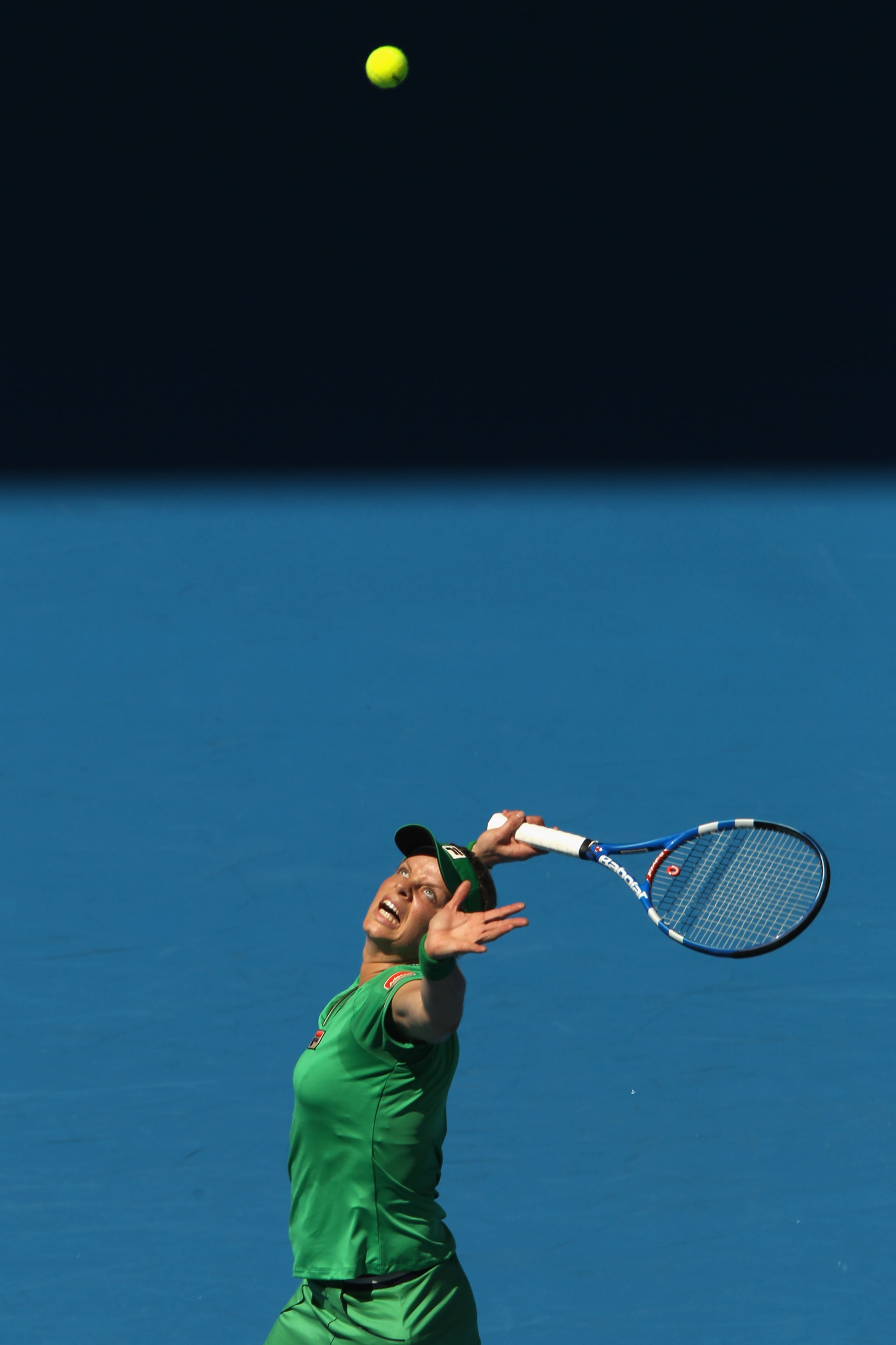 MELBOURNE, AUSTRALIA - JANUARY 20:  Kim Clijsters of Belgium serves in her second round match against Carla Suarez Navarro of Spain during day four of the 2011 Australian Open at Melbourne Park on January 20, 2011 in Melbourne, Australia.  (Photo by Clive