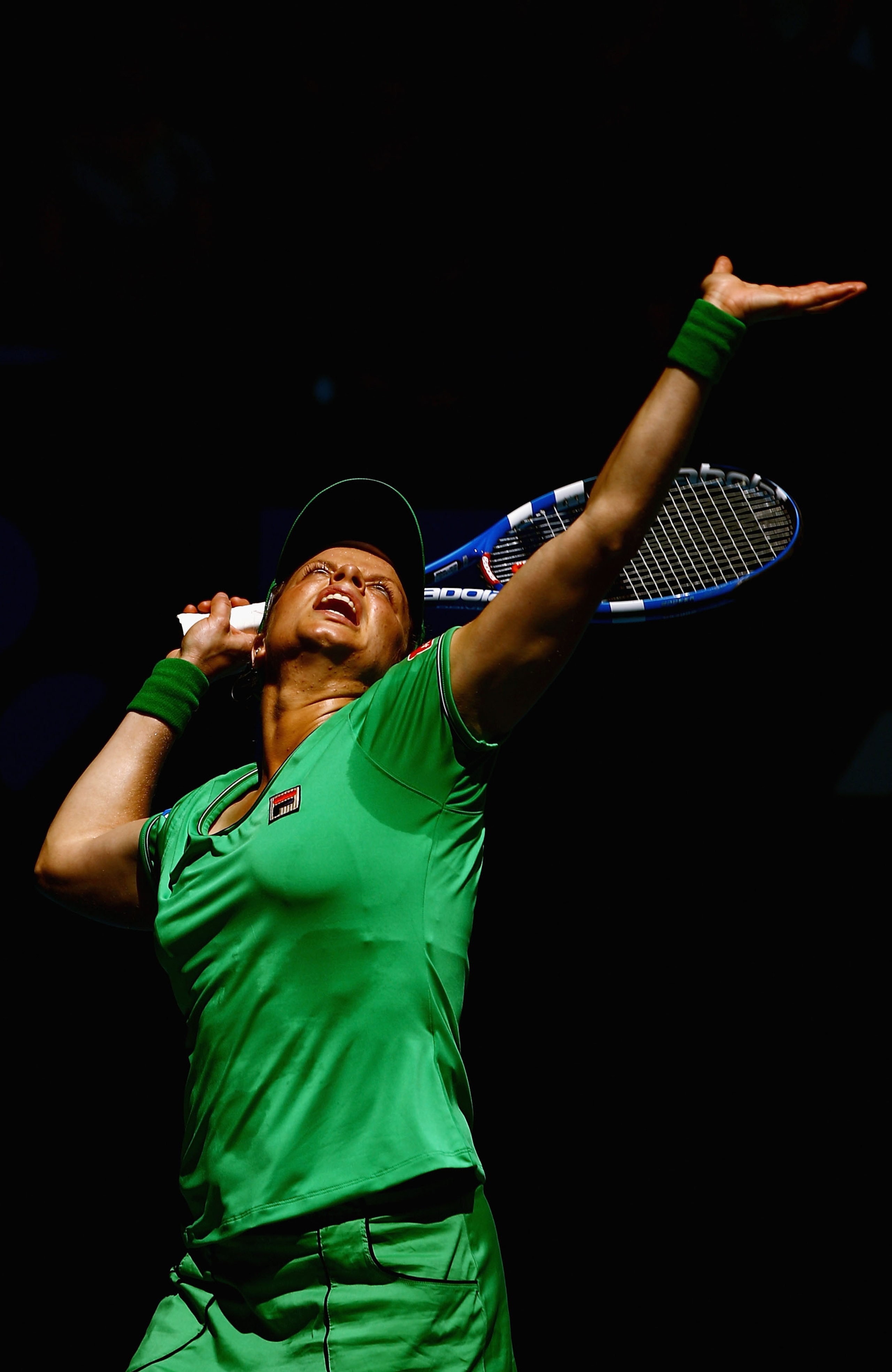 MELBOURNE, AUSTRALIA - JANUARY 20:  Kim Clijsters of Belgium serves in her second round match against Carla Suarez Navarro of Spain during day four of the 2011 Australian Open at Melbourne Park on January 20, 2011 in Melbourne, Australia.  (Photo by Quinn