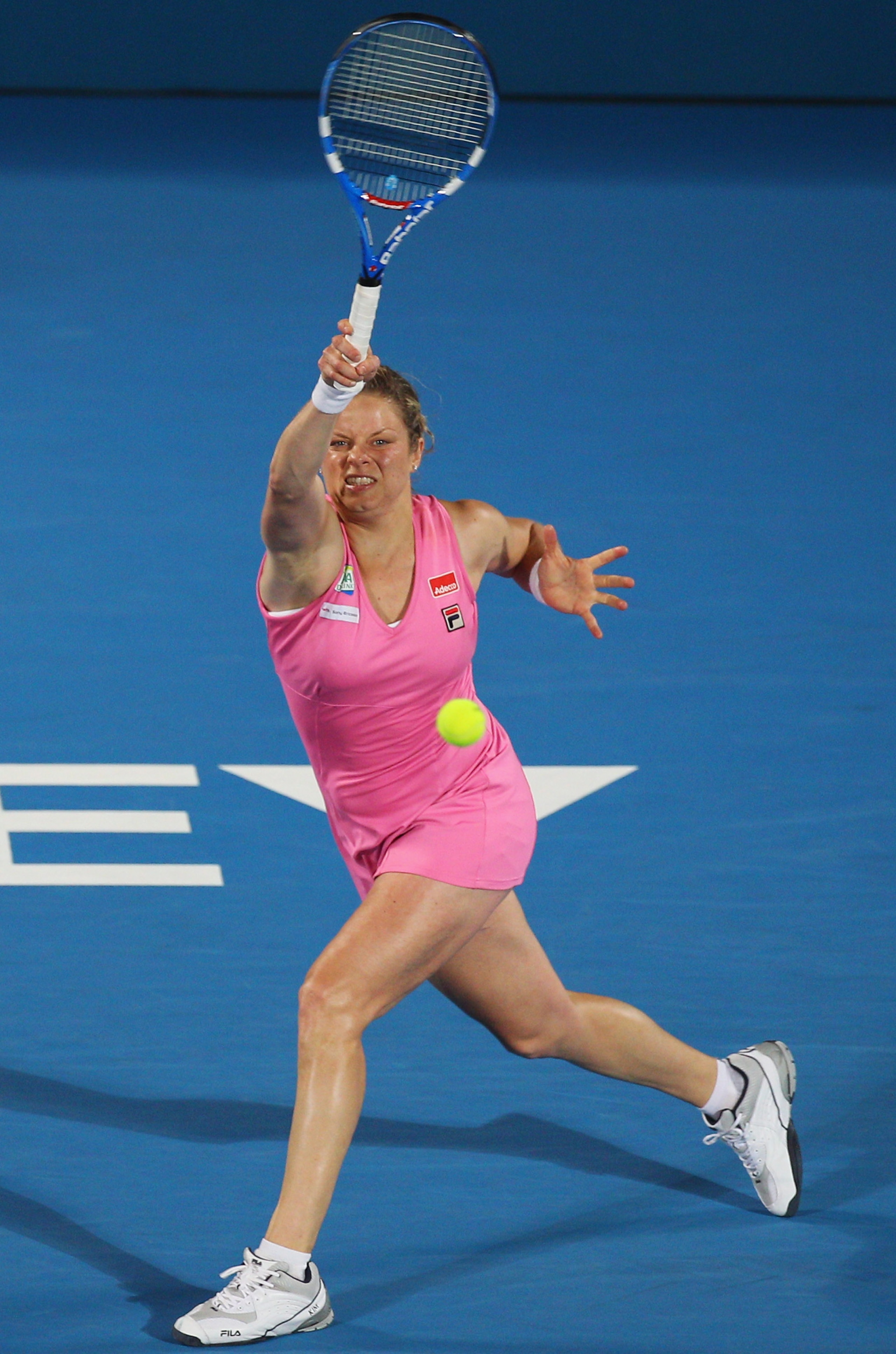SYDNEY, AUSTRALIA - JANUARY 14:  Kim Clijsters of Belgium plays a forehand in the women's final against Na Li of China during day six of the 2011 Medibank International at Sydney Olympic Park Tennis Centre on January 14, 2011 in Sydney, Australia.  (Photo
