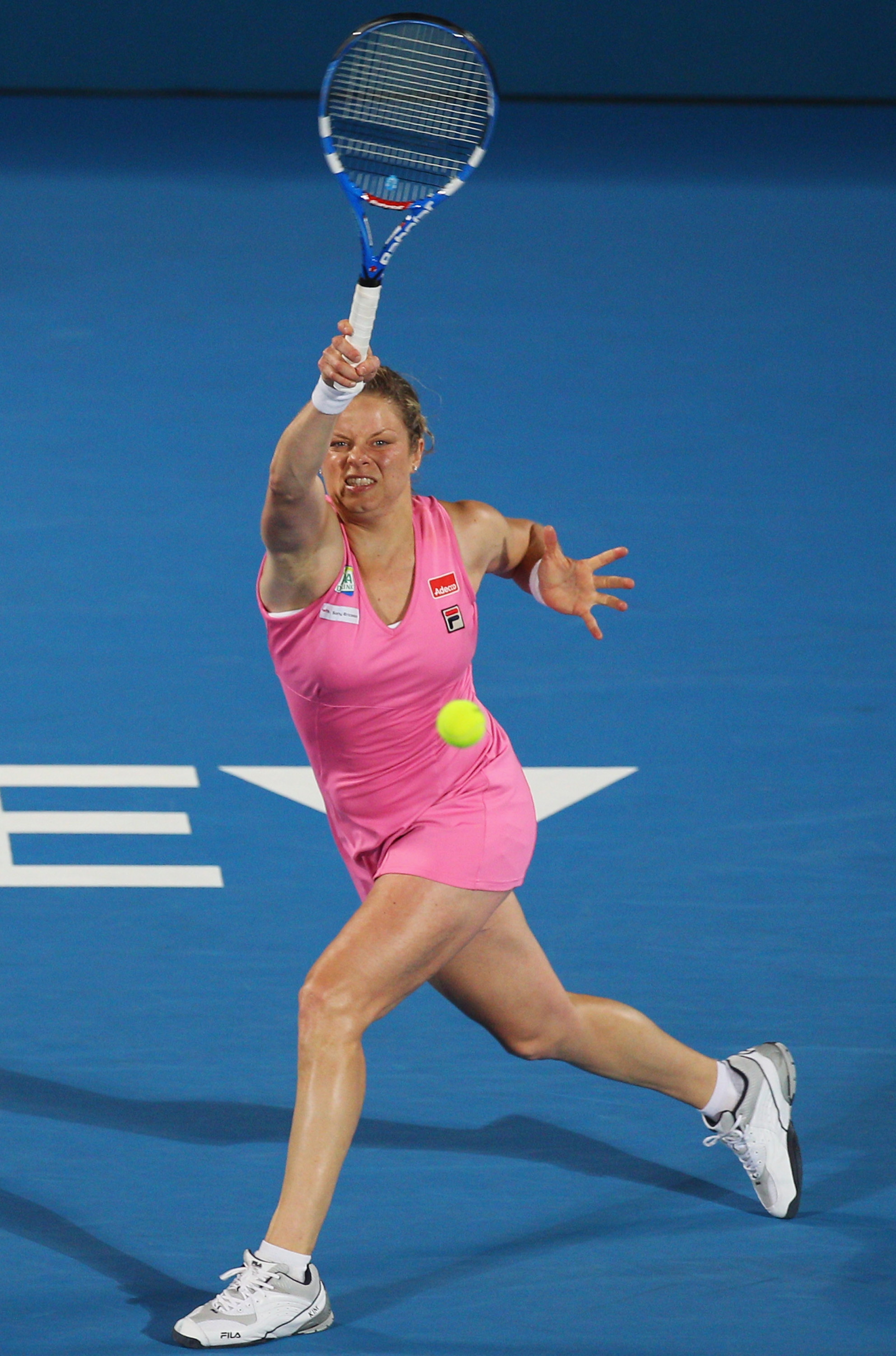 SYDNEY, AUSTRALIA - JANUARY 14:  Kim Clijsters of Belgium plays a forehand in the women's final against Na Li of China during day six of the 2011 Medibank International at Sydney Olympic Park Tennis Centre on January 14, 2011 in Sydney, Australia.  (Photo