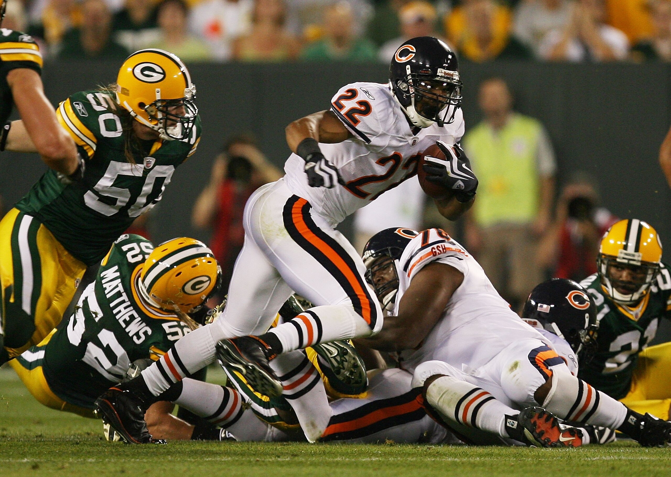 GREEN BAY, WI - SEPTEMBER 13: Matt Forte #22 of the Chicago Bears tries to gain yardage as A.J. Hawk #50 of the Green Bay Packers chases him on September 13, 2009 at Lambeau Field in Green Bay, Wisconsin. The Packers defeated the Bears 21-15.  (Photo by J