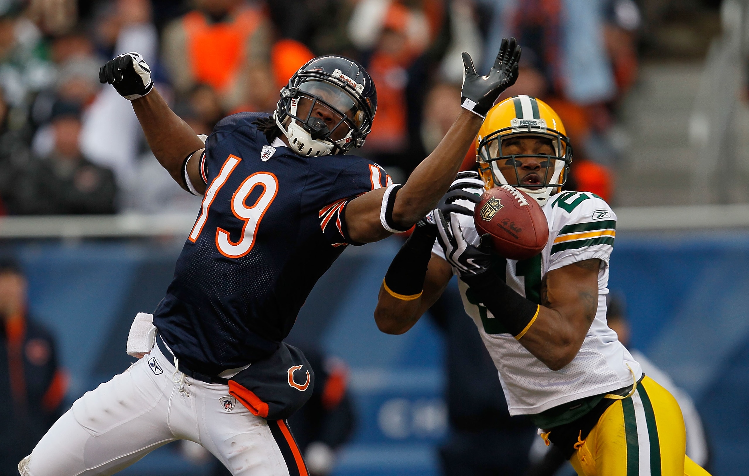 CHICAGO - DECEMBER 13: Charles Woodson #21 of the Green Bay Packers breaks up a pass intended for Devin Aromashodu #19 of the Chicago Bears at Soldier Field on December 13, 2009 in Chicago, Illinois. (Photo by Jonathan Daniel/Getty Images)