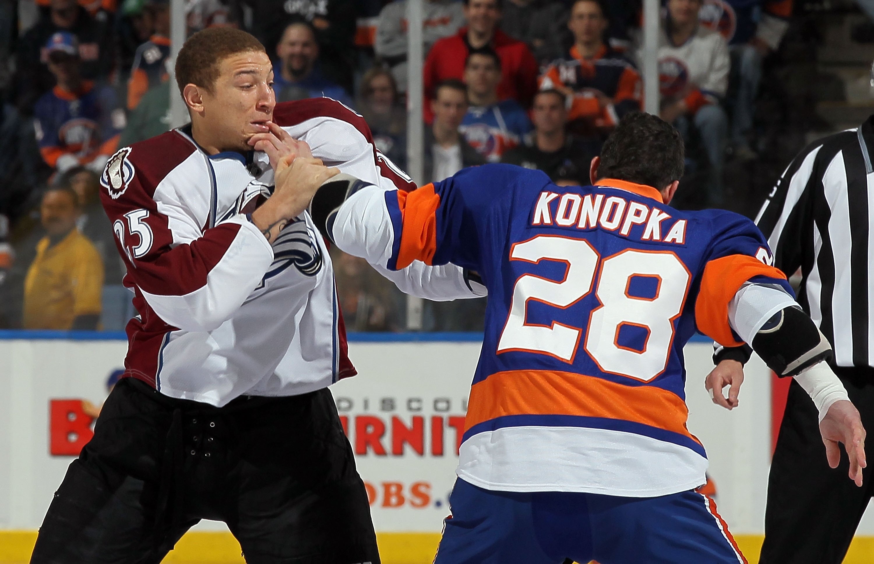 UNIONDALE, NY - OCTOBER 16:  Chris Stewart #25 of the Colorado Avalanche trades punches with Zenon Konopka #28 of the New York Islanders five seconds into their game on October 16, 2010 at Nassau Coliseum in Uniondale, New York.  (Photo by Jim McIsaac/Get