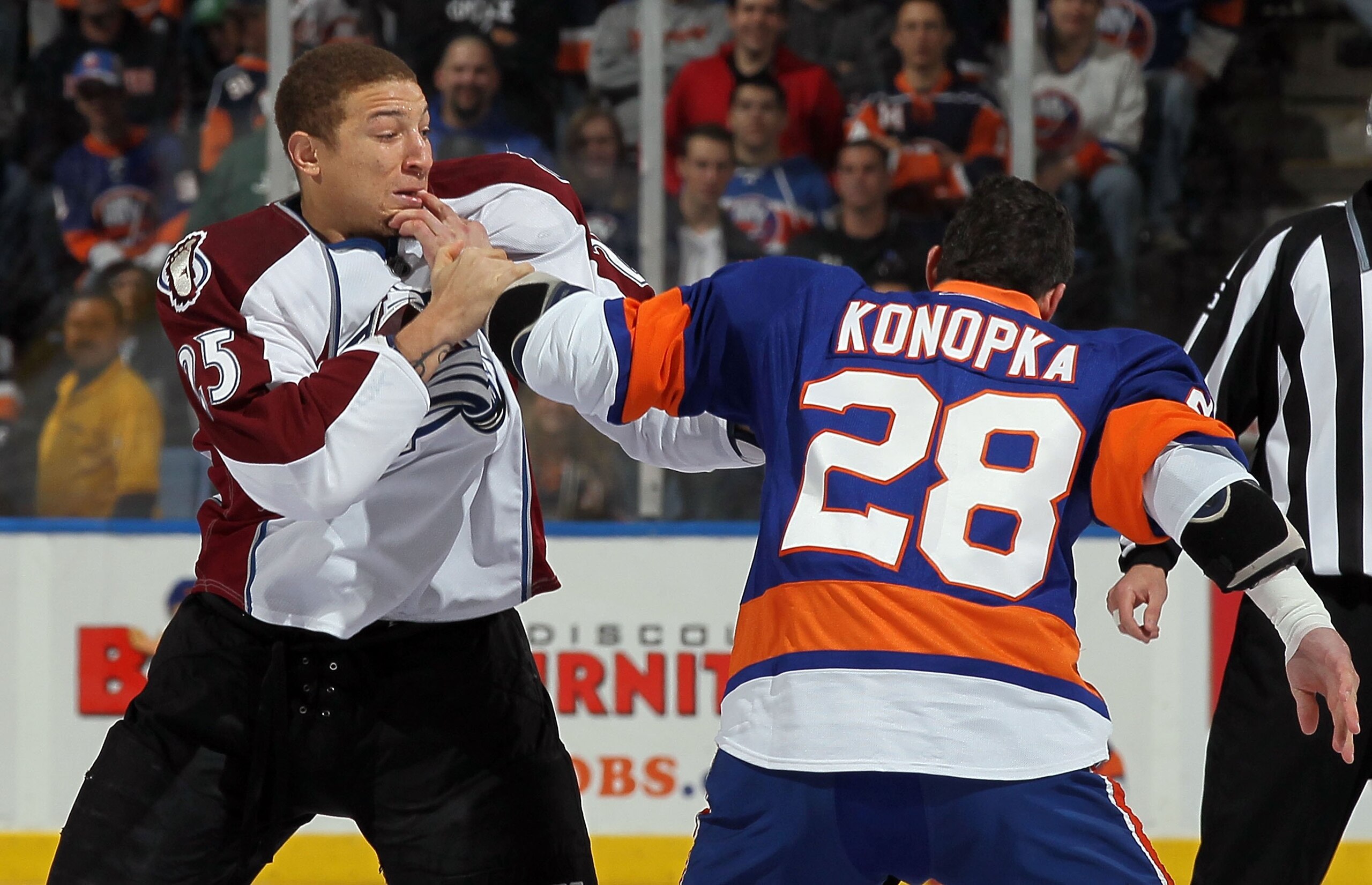 UNIONDALE, NY - OCTOBER 16:  Chris Stewart #25 of the Colorado Avalanche trades punches with Zenon Konopka #28 of the New York Islanders five seconds into their game on October 16, 2010 at Nassau Coliseum in Uniondale, New York.  (Photo by Jim McIsaac/Get